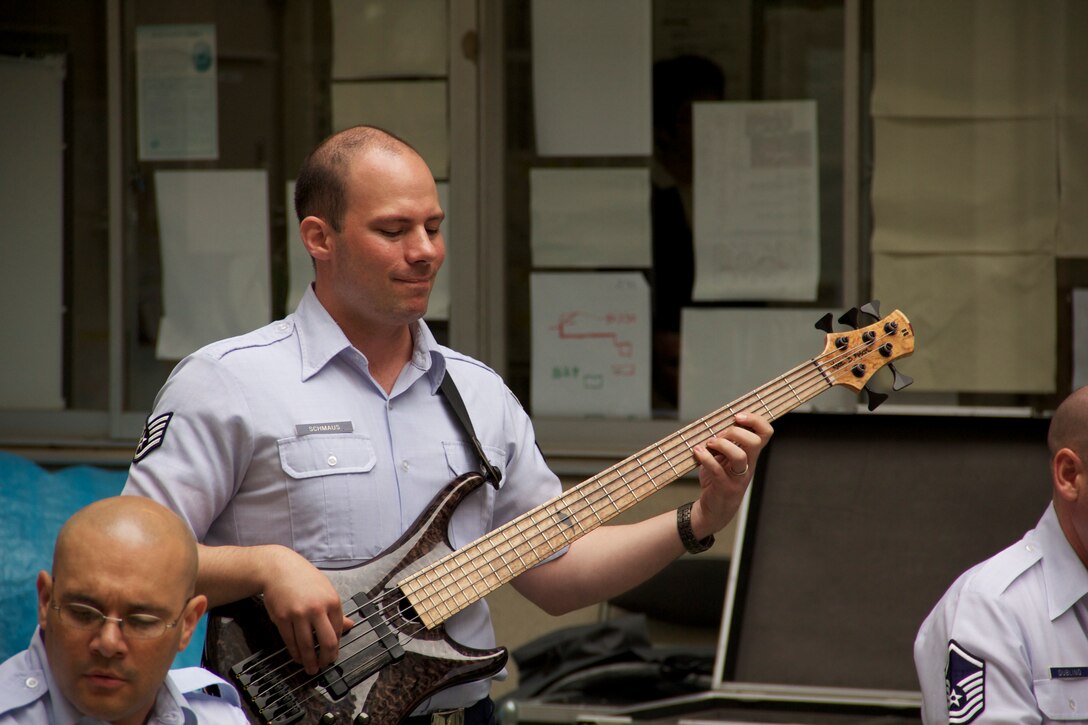 SSgt Mike Schmaus, bassist for Pacific Clave, digs in