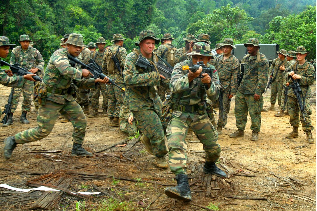 U.S. Marines and Malaysian army Rangers conduct military operations in urban terrain training during Cooperation Afloat Readiness and Training Malaysia 2011 in Terengganu, Malaysia, June 13, 2011. The Marines are assigned to the Landing Force Company. Malaysian Rangers are distinct from soldiers and serve in separate units.
