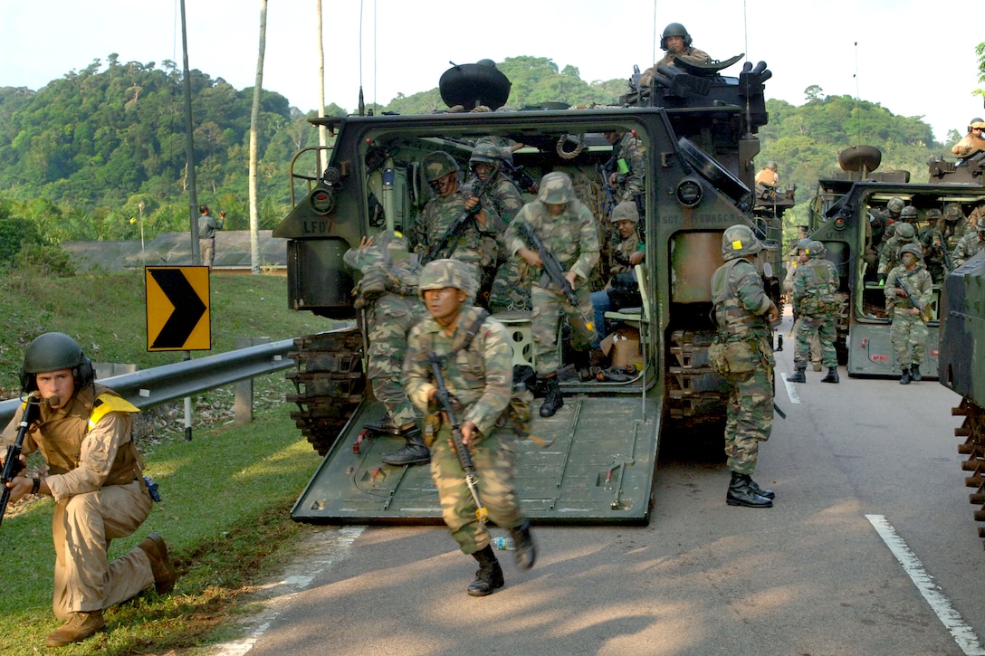 U.S. Marines and Malaysian army soldiers dismount their amphibious ...