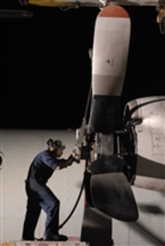 Petty Officer 2nd Class Omar Viraclass, assigned to Patrol Squadron 45, installs a propeller on the number two engine of a P-3C Orion aircraft in Sigonella, Sicily, on June 20, 2011.  Patrol Squadron 45 is deployed to Sicily supporting Operation Unified Protector.  