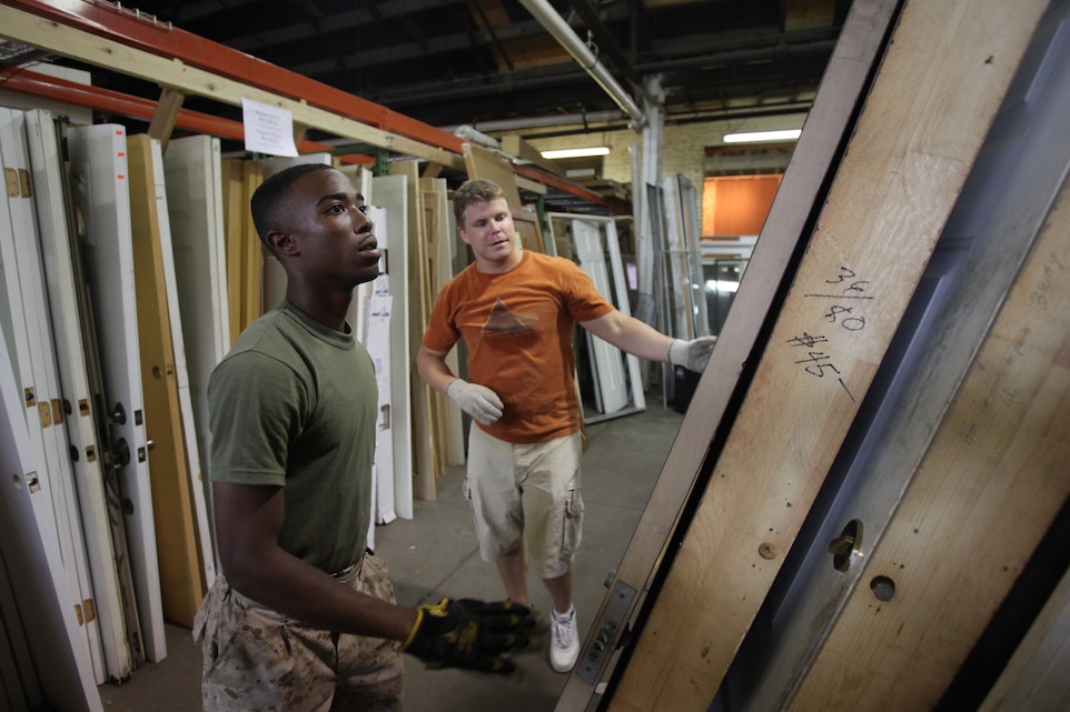 Lance Cpl. Julius Stoudmire and Kyle Schneider, a volunteer, stack donated doors at the Habitat for Humanity ReStore, June 23, 2011. Marines supported the store by organizing donated materials and disposing of unserviceable furniture, allowing customers better access.  Throughout Marine Week, Marines will be going throughout the St. Louis area, lending a helping hand to the local community.
