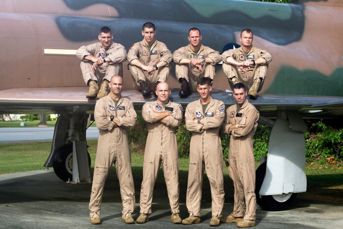 Marine Division Tactics Course aviation students (top) Maj. Jayson M. Tiger, a VMFA(AW)-533 pilot, Capt. Christopher P. Allain, a VMFA-232 pilot, Capt. Frank A. Machniak, a VMFA-314 pilot, Capt. Dustin B. Cook, a VMFA(AW)-225 pilot, (bottom) Capt. Scott W. Warman, Capt. Clayton D. Gard III, Maj. Neil A. Cordes, VMFA(AW)-533 weapon systems operators, and Capt. David C. Dunsworth, a VMFA(AW)-225 weapon systems operator, pose alongside an F-4 Phantom II here June 23.