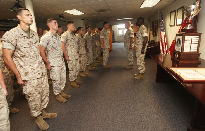 Marines of the 24th Marine Expeditionary Unit's command element stand in formation while the citation for the Lieutenant General "Chesty" Puller Outstanding Leadership Award is read by the 24th MEU's sergeant major, Sgt. Maj. John McGovern, June 23, 2011, at the unit's headquarters building.  The trophy and award were presented to the unit for its sustained excellence in all aspects of unit readiness.