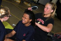 Barbara Griffin, a 17-year-old graduate of Canistoea High School, watches Kari Jondro, 17, from Prior Lake, Minn., put up Haleemah Abdus-Salam's hair with a sock-bun while attending a Recruiting Station Twin Cities female pool function June 24-25. Women are usually taught this hygiene technique by drill instructors once they arrive at boot camp. The purpose of the pool function involved preparing our nation's future warriors for obstacles they'll face at recruit training. Abdus-Salam, 18, from Tempe, Ariz., ships off to Parris Island, S.C., on March 26, 2012. Griffin was recruited out of the Sioux Falls, S.D., office. For additional imagery from the event, visit www.facebook.com/rstwincities.