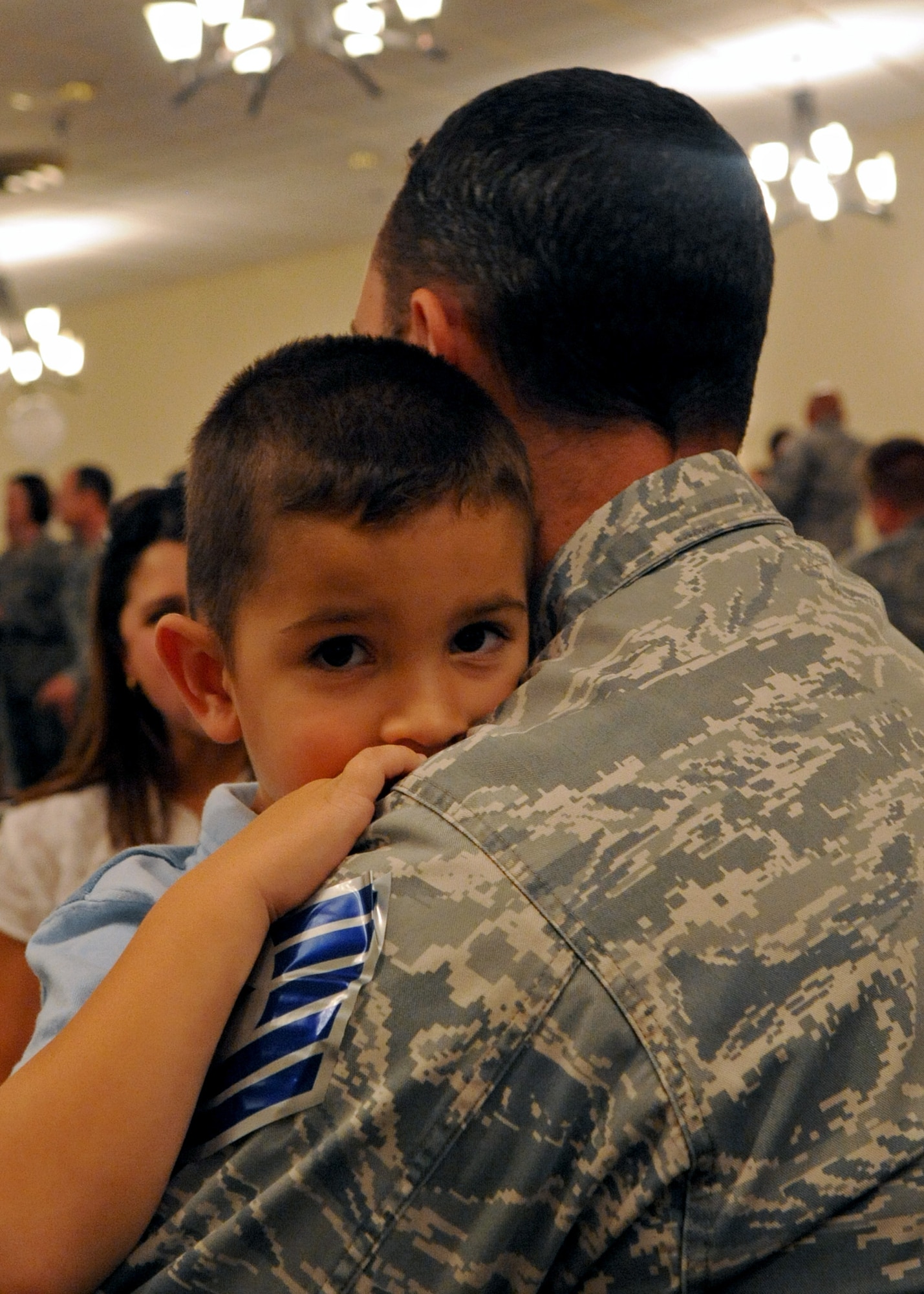 Braden Morrison, 4, gives his dad, Staff Sgt. Ryan Morrison, 26th Operational Weather Squadron, a hug during the technical sergeant promotion party at the Stripes Club June 23. Sergenat Morrison is one of 131 staff sergeants from Barksdale selected for promotion to technical sergeant. Those selected for technical sergeant will be promoted according to their promotion sequence number beginning in August.(U.S. Air Force photo/Senior Airman La'Shanette V. Garrett)(RELEASED)