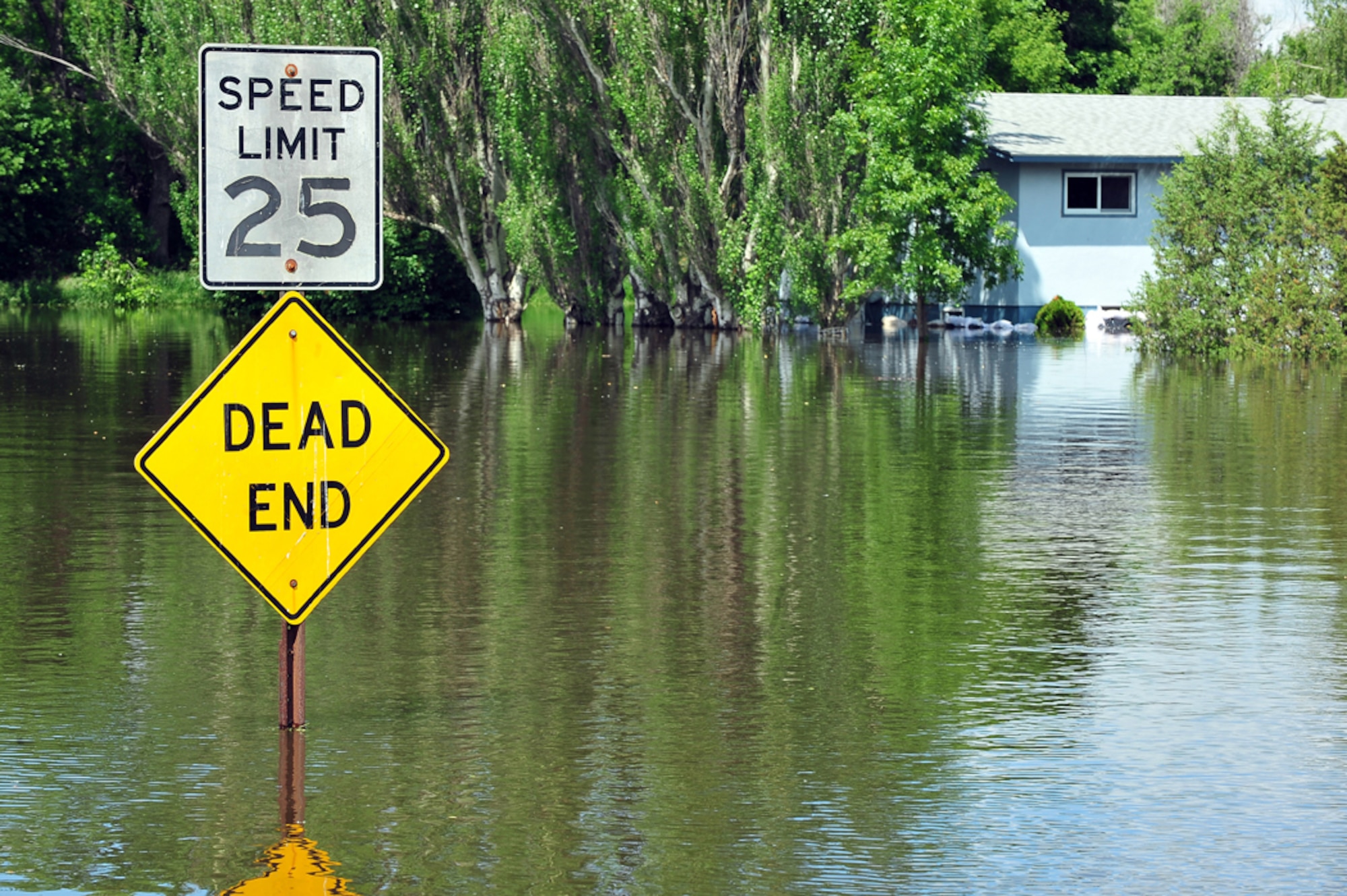 The Souris River flows down a public street outside of Minot Air Force Base, N.D., June 22, 20111. The river breached levees there forcing more than 11,000 residents to evacuate.  The flood also is affecting nearly 1,000 Airmen from nearby Minot Air Force Base. (U.S. Air Force photo/Senior Airman Jesse Lopez)
