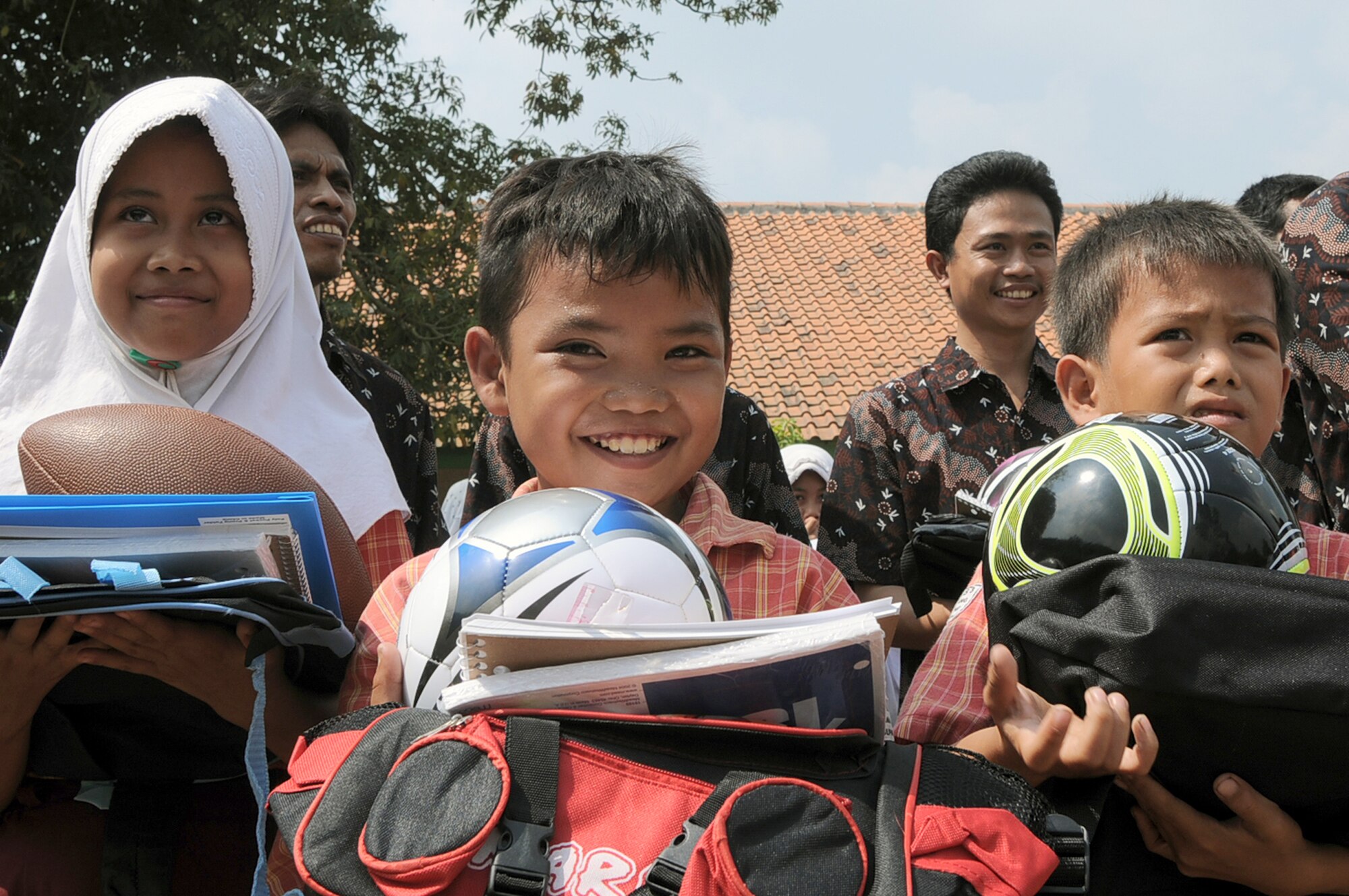 Indonesian schoolchildren receive school supplies and sports equipment from Airmen during a goodwill visit to an elementary school in Binguang district, Indonesia, as part of Cope West 11.  (U.S. Air Force photo/Capt. Raymond Geoffroy)