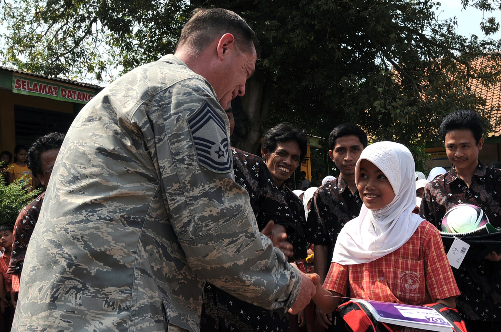 Chief Master Sgt. Terry Webb gives school supplies to an Indonesian schoolgirl June 23, 2011, during a goodwill visit to an elementary school in Binguang district, Indonesia, as part of Cope West 11. Chief Webb is the first sergeant with the Cope West 11 detachment from Yokota Air Base, Japan. (U.S. Air Force photo/Capt. Raymond Geoffroy)