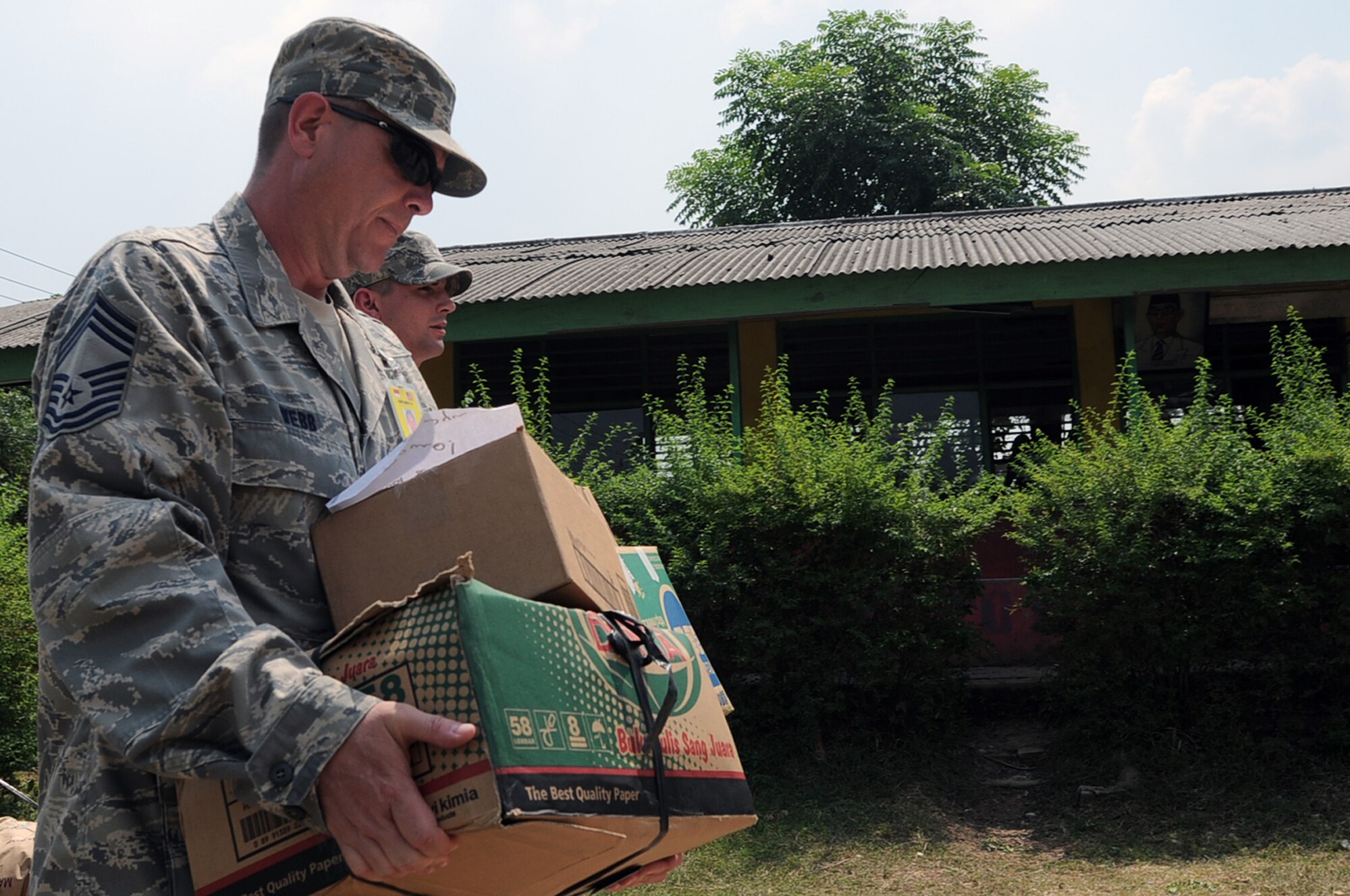 Chief Master Sgt. Terry Webb carries donated school supplies during a goodwill visit to an elementary school in Binguang district, Indonesia, as part of Cope West 11. Chief Webb is the first sergeant with the Cope West 11 detachment from Yokota Air Base, Japan. (U.S. Air Force photo/Capt. Raymond Geoffroy)