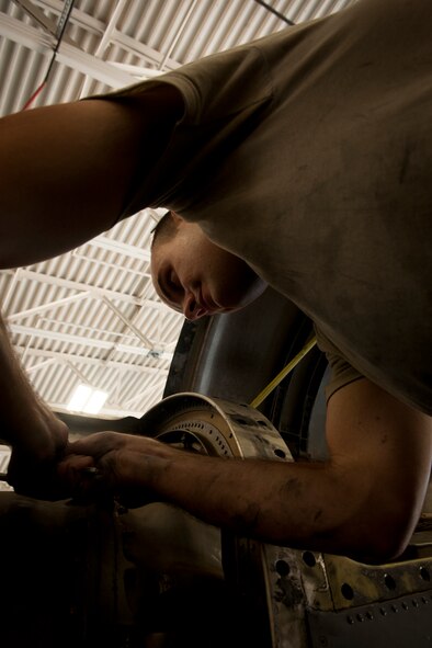 U.S. Air Force Airman 1st Class Goran Ciganovic, 23rd Equipment Maintenance Squadron aerospace propulsion journeyman, loosens a screw on an HC-130P Combat King engine during a 550-day inspection at Moody Air Force Base, Ga., June 20, 2011. During the 2 ½ week period needed to complete a 550-day inspection, an estimated five different squadrons work on the C-130. (U.S. Air Force photo by Airman 1st Class Joshua Green/Released)          