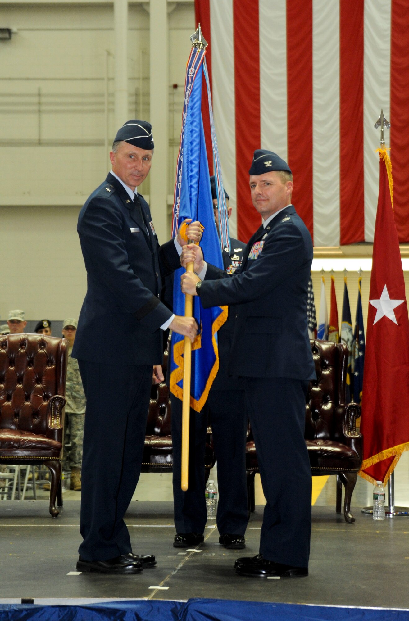 Col. John M. Wood assumes command during the 87th Air Base Wing and Joint Base McGuire-Dix-Lakehurst change of command ceremony June 24 in Hangar 2201 at JB MDL. During the event, Brig. Gen. Gina M. Grosso relinquished command to Col. John M. Wood. (U.S. Air Force photo by 2nd Lt. David J. Murphy/Released)