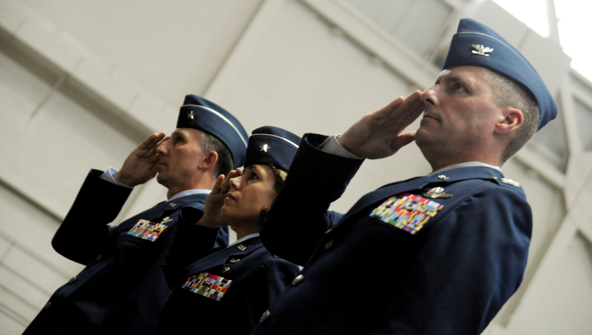 (From left to right) Brig. Gen. William J. Bender, Brig. Gen. Gina M. Grosso and Col. John M. Wood, salute during the 87th Air Base Wing Change of Command Ceremony June 24 in Hangar 2201 at Joint Base McGuire-Dix-Lakehurst. During the event, Grosso relinquished command to Wood. (U.S. Air Force photo by 2nd Lt. David J. Murphy/Released)