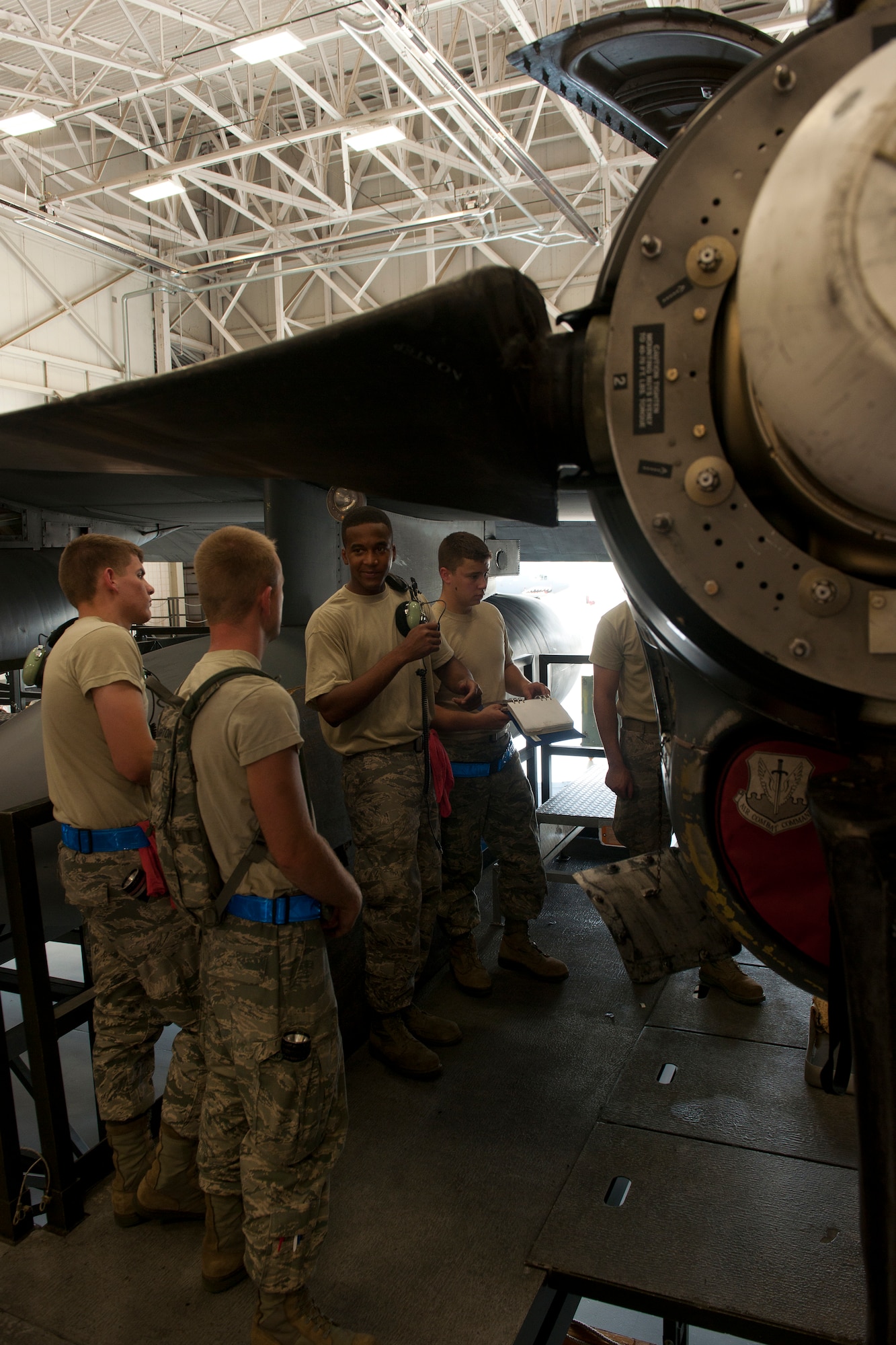 U.S. Air Force Airmen gather around an Allison T56-A-15 turboprop engine during an HC-130P Combat King 550-day inspection at Moody Air Force Base, Ga., June 20, 2011. The more experienced Airmen used the time to train new Airmen on the procedures and steps to follow when inspecting the engine. (U.S. Air Force photo by Airman 1st Class Joshua Green/Released)        