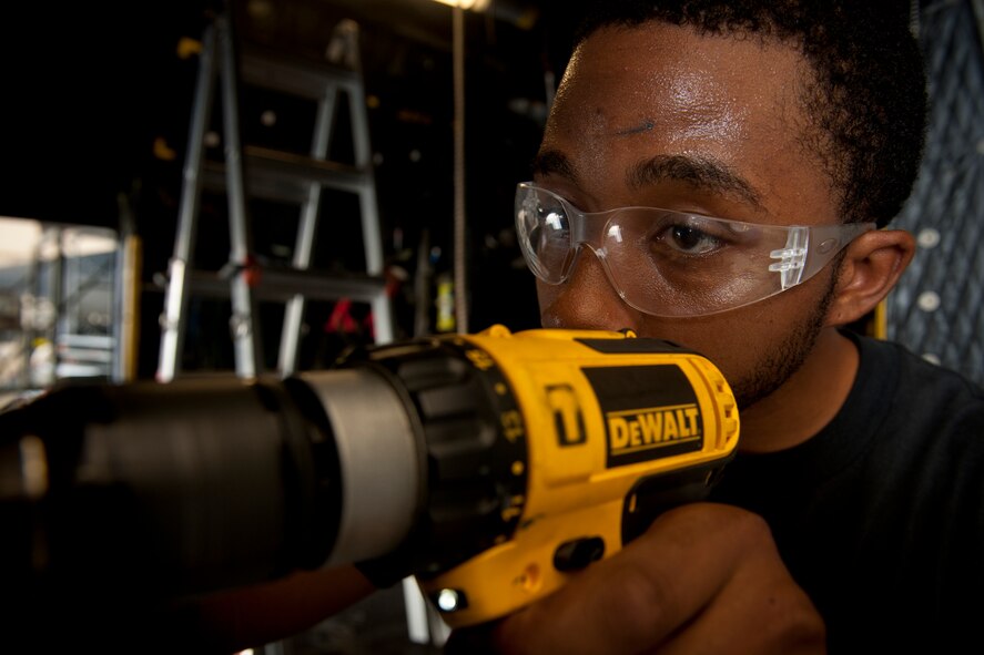 U.S. Air Force Staff Sgt. Ron Goldon, 23rd Equipment Maintenance Squadron aircraft structural maintenance journeyman, drills into a side door panel during an HC-130P Combat King 550-day inspection at Moody Air Force Base, Ga., June 20, 2011. By drilling new holes, Sergeant Goldon was able to replace a piece of the door panel. (U.S. Air Force photo by Airman 1st Class Joshua Green/Released)      