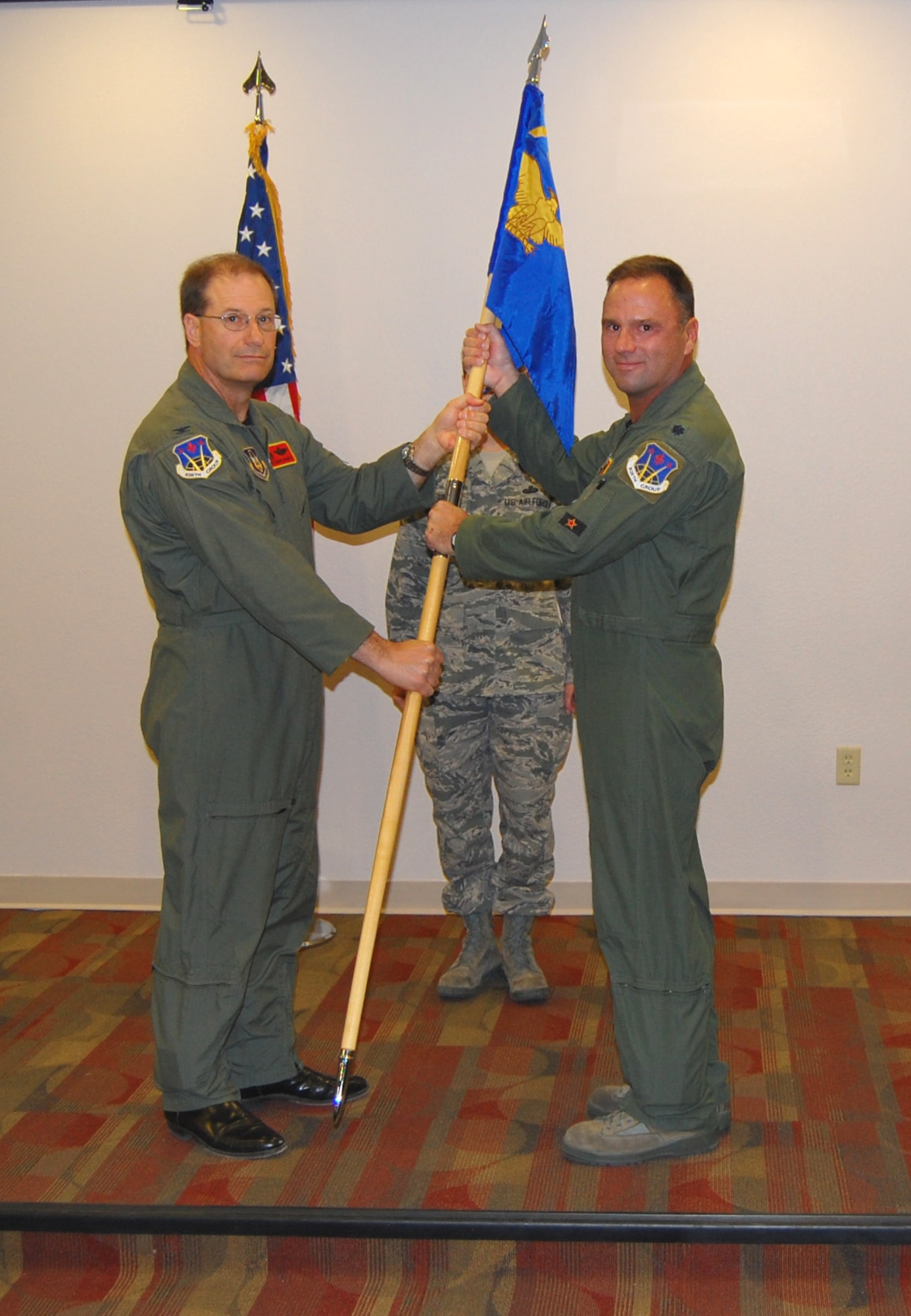 NELLIS AIR FORCE BASE, Nev. (Right) -- Lt. Col. Dean Caldwell, newly appointed 706th Fighter Squadron commander, receives the guideon from Col. Herman Brunke, Jr., 926th Group commander, during a change of command ceremony here June 24.