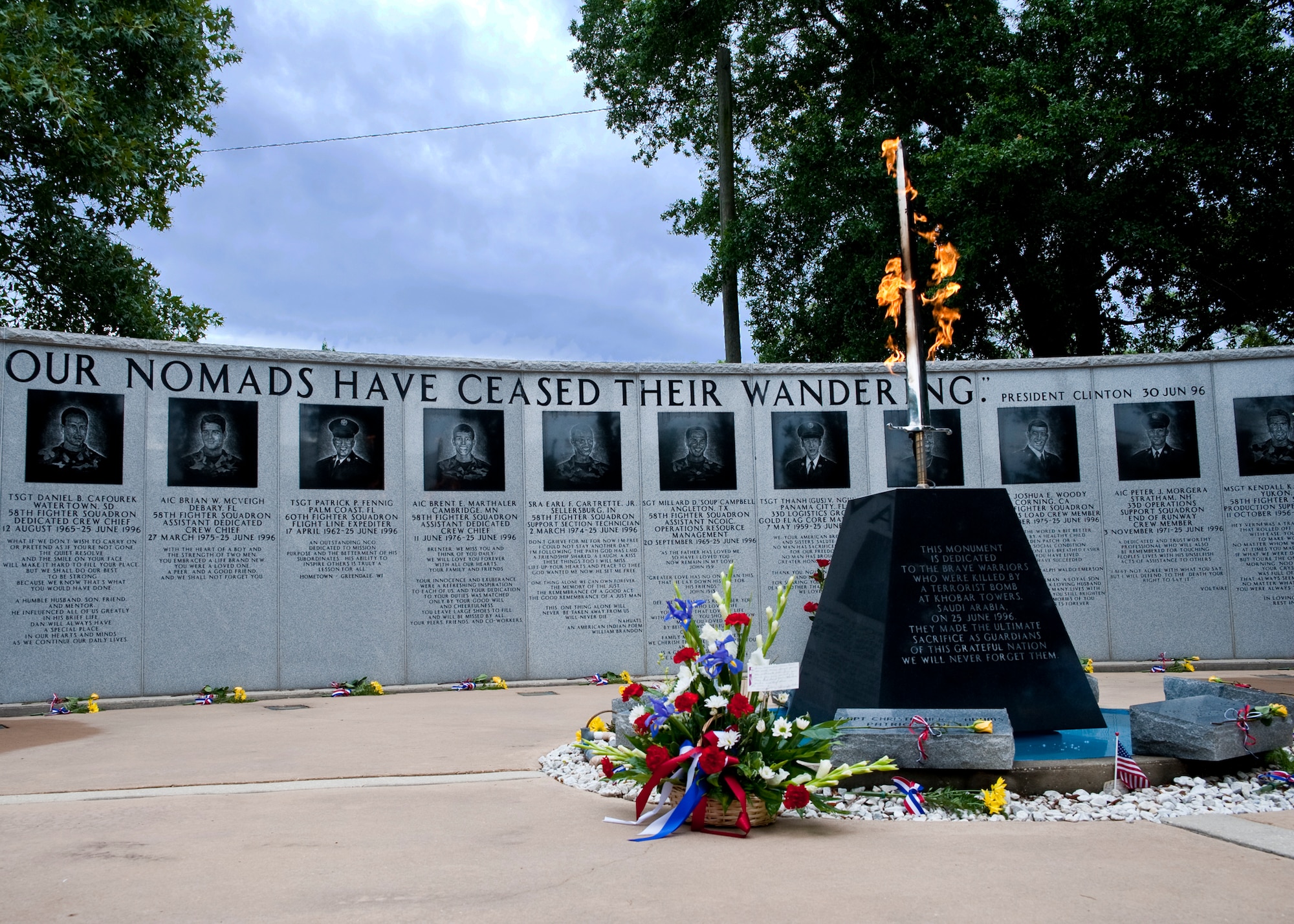 The Khobar Towers eternal flame monument and memorial wall at Eglin Air Force Base, Fla., were dedicated one year after the tragedy June 25, 1996.   Each year, a ceremony is held by the 33rd Fighter Wing Nomads to commemorate their brothers who’ve “ceased their wandering.”  (U.S. Air Force photo/Samuel King Jr.)