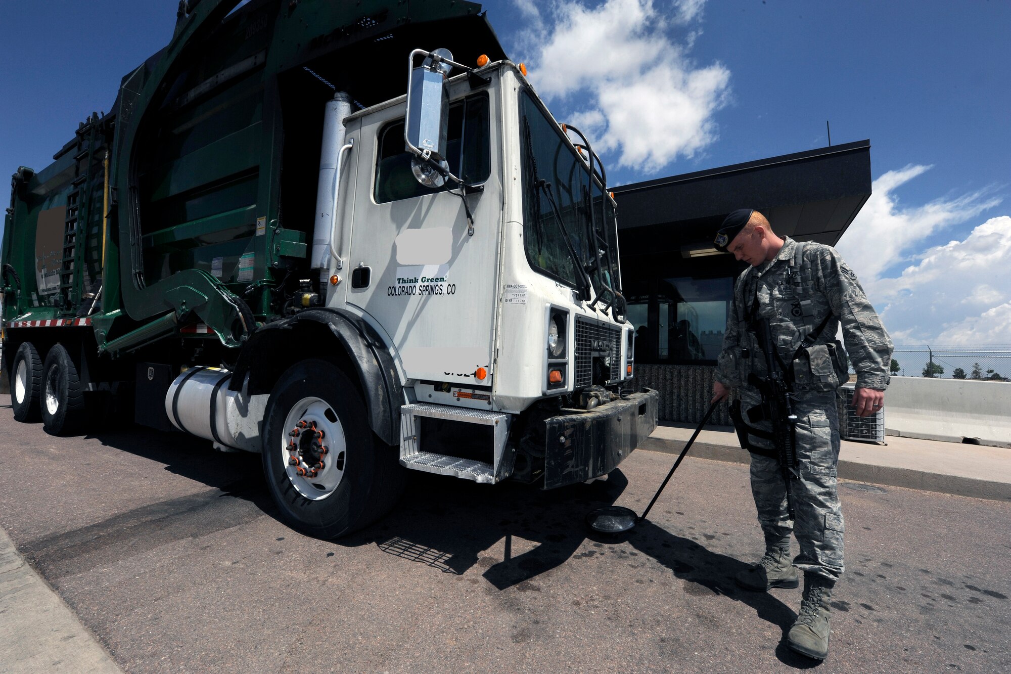 SCHRIEVER AIR FORCE BASE, Colo. -- Airman First Class Michael Pope of the 50th Security Forces Squadron provides security inspections at the west entrapment June 15.  (U.S. Air Force Photo/David Ahlschwede)