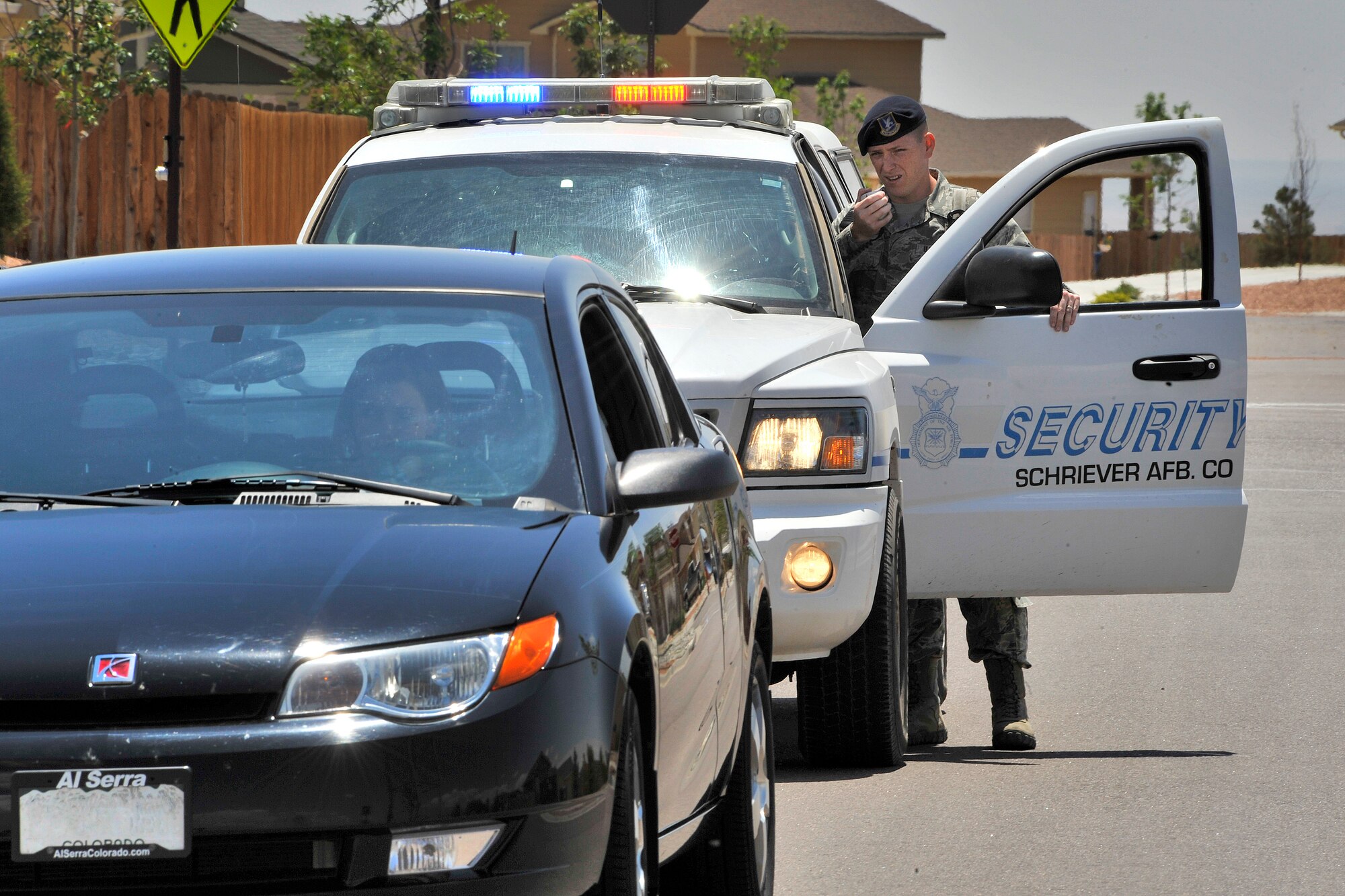 Airman 1st Class Andrew Poirier makes a simulated traffic stop while demonstrating the squadron's law enforcement capabilities June 15, 2011, at Schriever Air Force Base, Colo. The squadron conducts scheduled exercises to provide training opportunities for its members. Airman Poirier is a 50th Security Forces Squadron patrolman. (U.S. Air Force photo/Dennis Rogers)