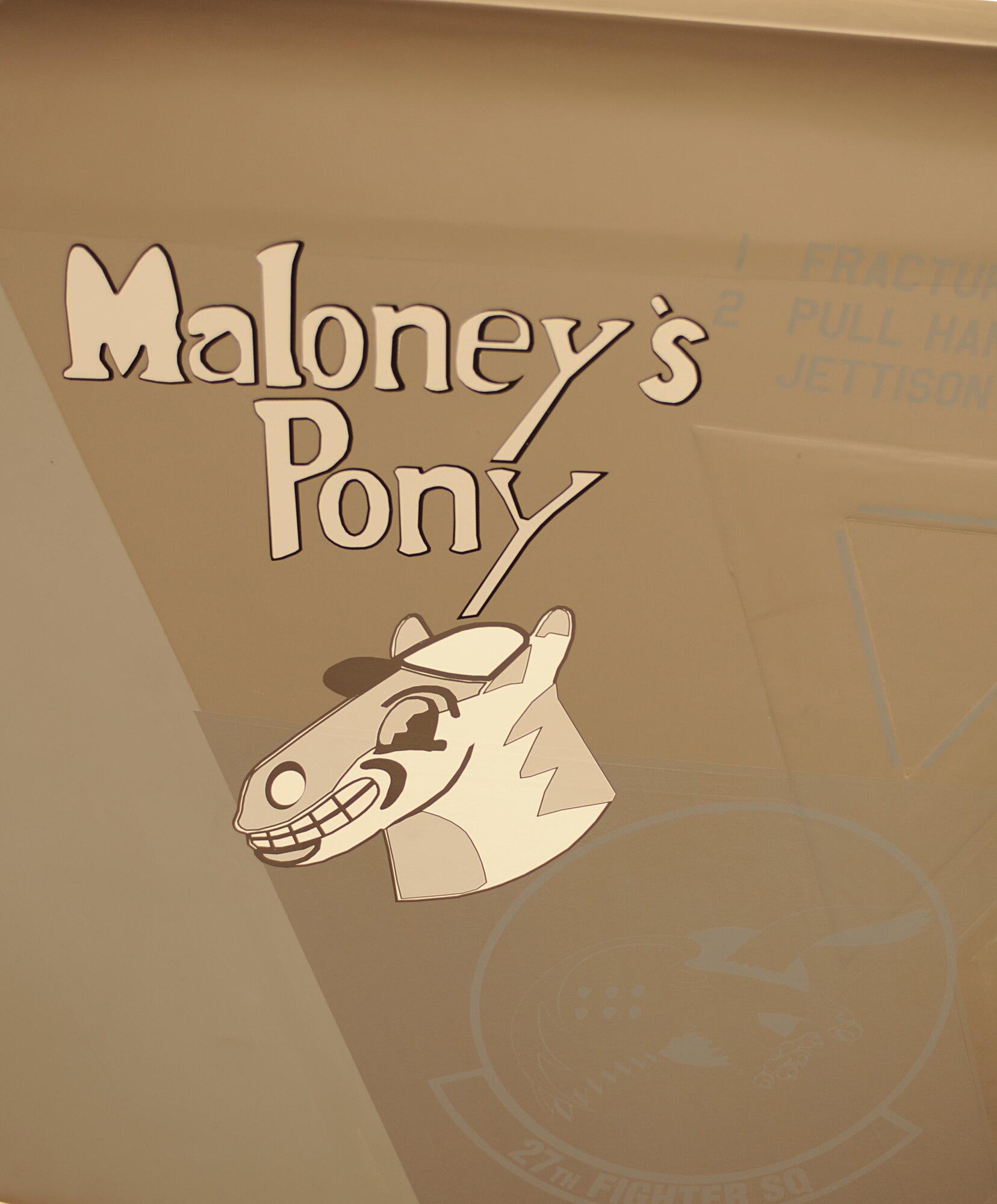The Maloney’s Pony artwork is displayed on the body of an F-22 Raptor at Langley Air Force Base, Va., June 24, 2011. The artwork was painted on the Raptor in honor of Maj. Thomas E. Maloney, the 27th Fighter Squadron’s highest scoring Ace of World War II. (U.S. Air Force photo by Airman 1st Class Teresa Cleveland/Released)
