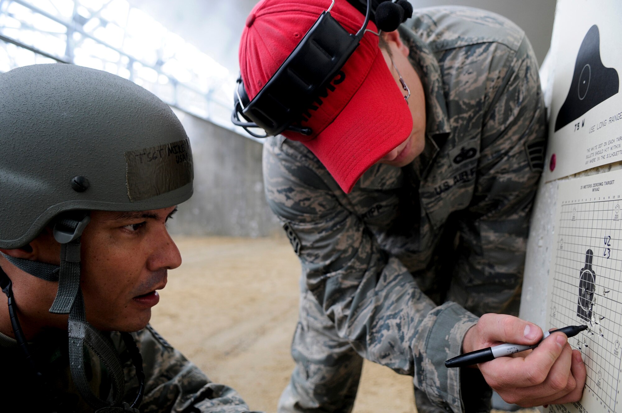 Tech. Sgt. Michael Tateishi watches Staff Sgt. James Kipp, his instructor, indicate sight corrections on the zeroing target May 24, 2011, during combat arms training at Kadena Air Base, Japan. (U.S. Air Force photo/Airman 1st Class Maeson L. Elleman)
