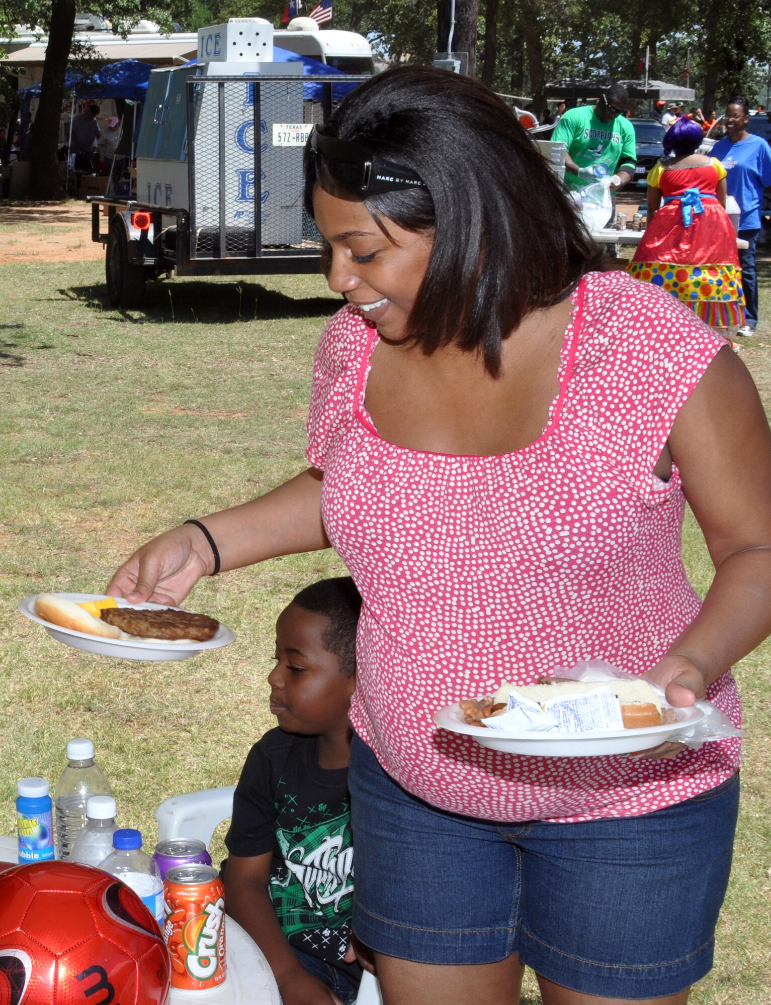 Airman 1st Class Devin Tate and her son, Jaylon, enjoy the picnic lunch during the 301st  Fighter Wing Family Day June 4. Members of the Air Power Council helped cook hamburgers, hotdogs and brisket for the event. (U.S. Air Force photo/Staff Sgt. Chris Bolen) 
