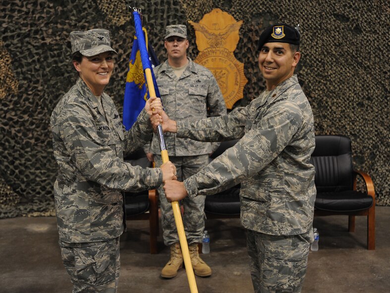 Maj. Frank N. Reyes receives the 319th Security Forces Squadron guidon from Col. Tammy Knierim, 319th Mission Support Group commander, during a change-of-command ceremony June 23, 2011, on Grand Forks Air Force Base. N.D. (U.S Air Force photo/Staff Sgt. Suellyn Nuckolls) 

