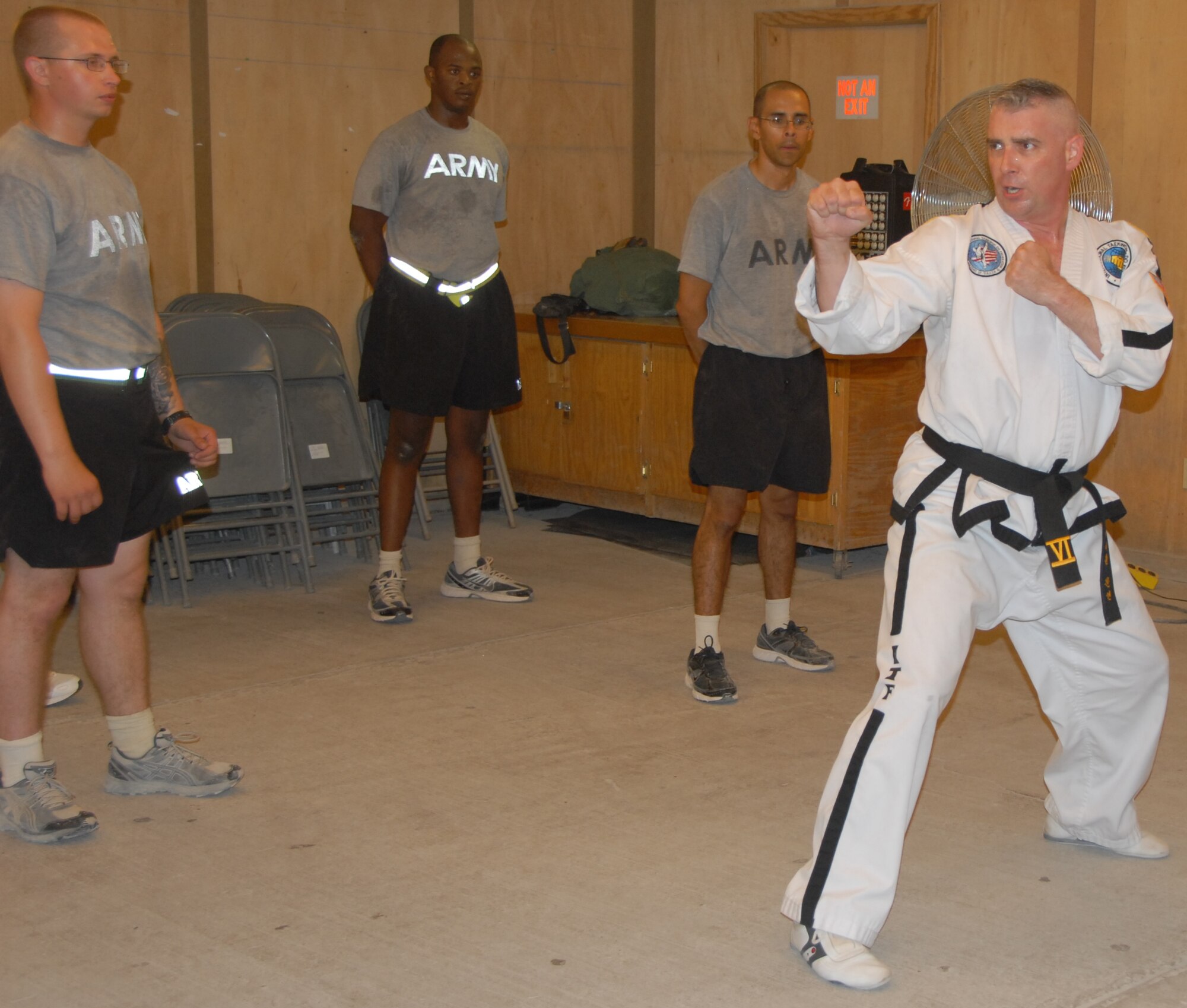 Technical Sgt. Michael Munyon demonstrates tae kwon do technique during a class June 21, 2011, at Kandahar Airfield, Afghanistan. Sergeant Munyon teaches while wearing a traditional martial arts robe called a do-boke, which he was given permission to wear to distinguish himself as an instructor. Sergeant Munyon is deployed to KAF as a member of the 466th Air Expeditionary Squadron, flight line security office.
