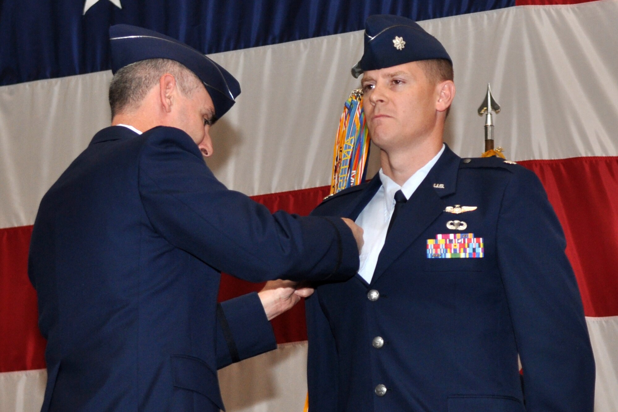 Colonel John M. Vitacca, commander, 2nd Operations Group, pins a command badge on Lt. Col. W. Heath Wharton, commander, 11th Bomb Squadron, during the change of command ceremony held Thursday, June 23, 2011, in Hoban Hall at Barksdale Air Force Base, La. Colonel Wharton took the reins of the 11th BS from Lt. Col. Kieran T. Denehan, who is headed to California for his next assignment. The 11th BS works alongside the 93rd Bomb Squadron as partners in the B-52 Formal Training Unit at Barksdale, which trains flight crews for the B-52 Stratofortress. To accomplish this task of forging new aviators into Combat Ready B-52 crewmembers takes the work of both AF Reserve and Active Duty Members. (U.S. Air Force photo/Tech. Sgt. Jeff Walston)