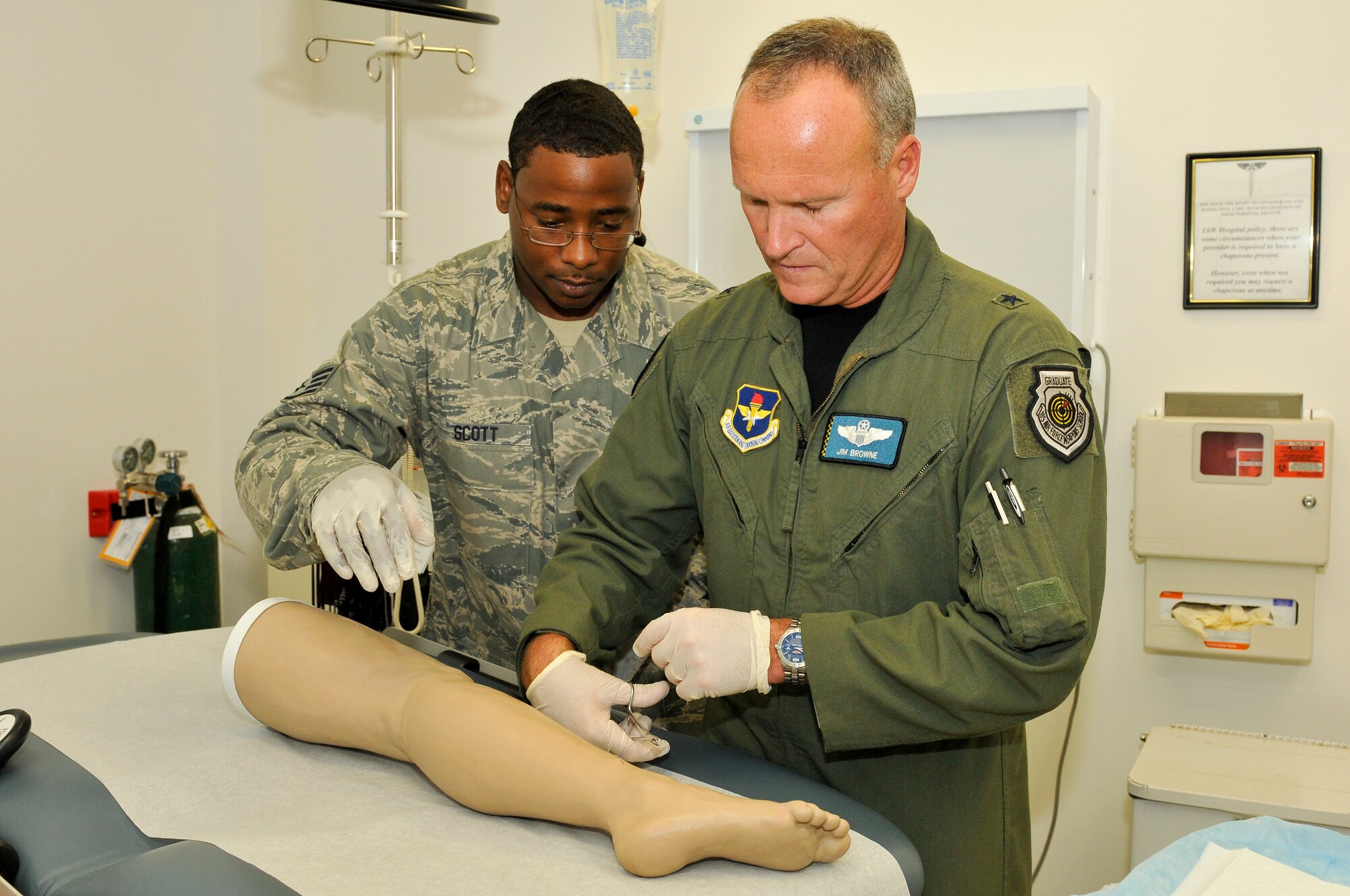 Brigadier Gen. James S. Browne, 325th Fighter Wing commander, practices sewing up a wound with stitches while Staff Sgt. Desmond Scott, 325th Medical Operations Squadron, provides assistance. (U.S. Air Force photo by Lisa Norman) 
