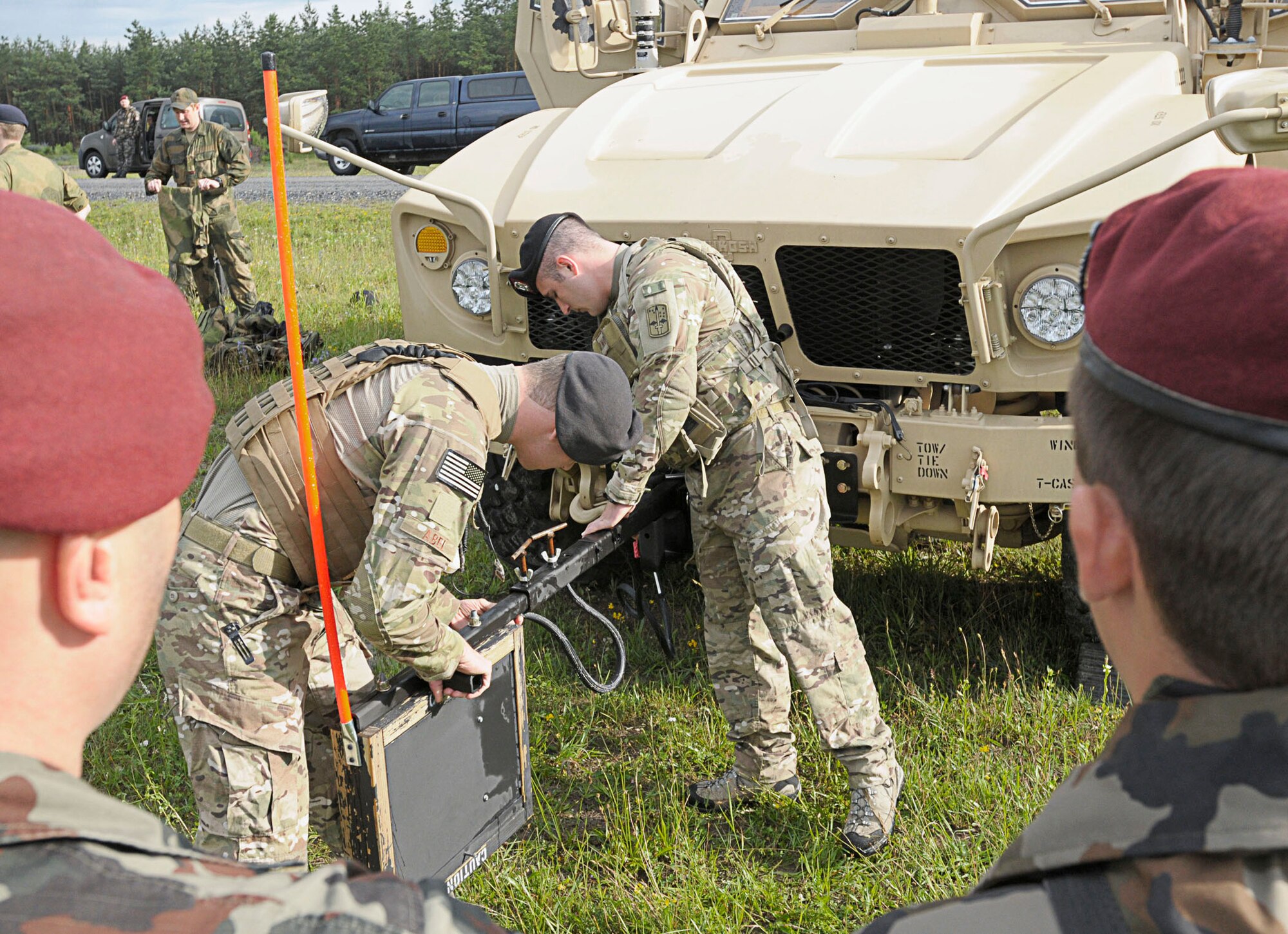 Airman 1st Class Anthony Abel and Airman 1st Class Anthony Puccaroni demonstrate an improvised explosive device countermeasure called a "rhino" to Slovenian army members June 22, 2011, during the opening ceremony for Allied Strike 2011 at Grafenwoher Training Area, Germany. Airmen Abel and Puccaroni assigned to the 2nd Air Support Operations Squadron. (U.S. Air Force photo/Airman 1st Class Desiree W. Esposito)