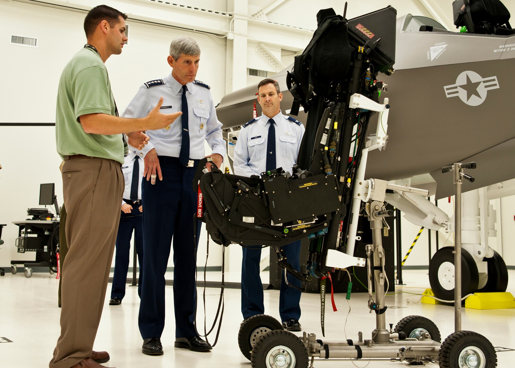 Air Force Chief of Staff Gen. Norton Schwartz (middle) learns about the new improvements in the ejection seat installed in the F-35 Joint Strike Fighter June 23, 2011, at Eglin Air Force Base, Fla.  The general visited the Khobar Towers memorial, 58th Fighter Squadron and the JSF Academic Training Center during his tour of the F-35’s new home, the 33rd Fighter Wing.  The 33rd FW is a joint graduate flying and maintenance training wing for the F-35A, B, and C.  (U.S. Air Force photo/Samuel King Jr.)