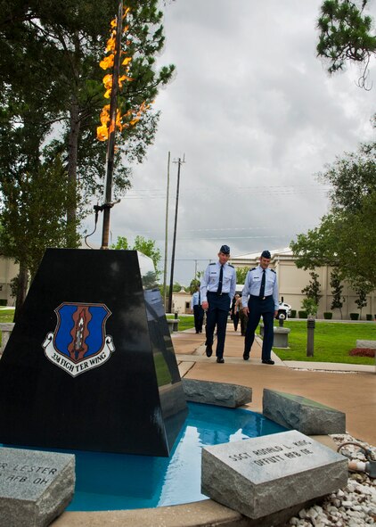 Air Force Chief of Staff Gen. Norton Schwartz and Col. Andrew Toth, 33rd Fighter Wing commander, walk to the flaming sword of the Khobar Towers Memorial two days prior to the 15th anniversary of the tragedy during a tour of the 33rd FW June 23, 2011, at Eglin Air Force Base, Fla.  Nineteen Airmen—12 of whom were members of the 33rd FW—lost their lives in the bombing June 25, 1996.  During a visit to Eglin, the general also visited the first F-35 squadron, the 58th Fighter Squadron, and the JSF Academic Training Center.  (U.S. Air Force photo/Samuel King Jr.)