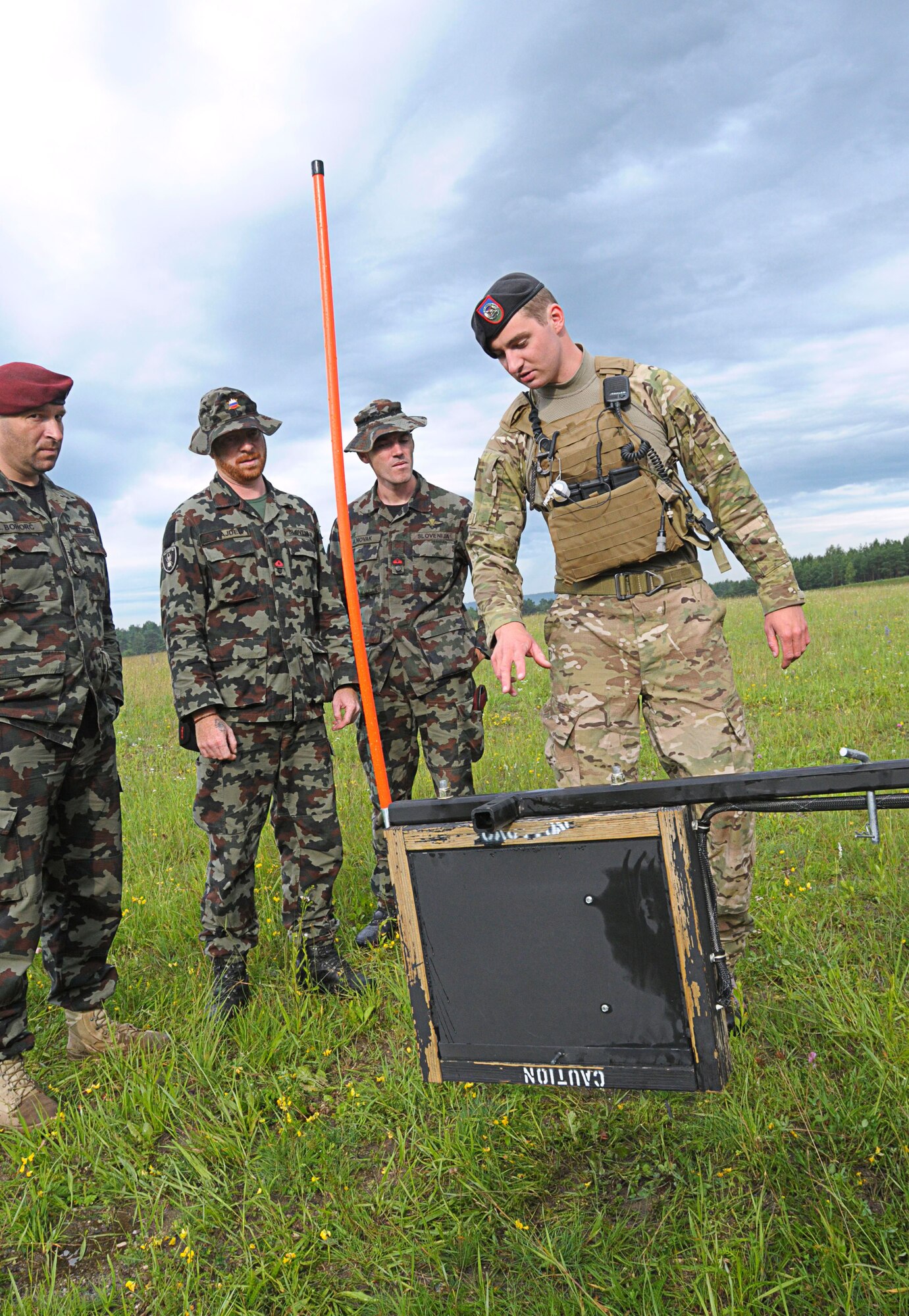 U.S. Air Force Airman 1st Class Anthony Abel, a ROMAD with the 2nd Air Support Operations Squadron, demonstrates an Improvised Explosive Device countermeasure called a “Rhino” to Slovenian army personnel during the opening ceremony for Allied Strike 2011, Grafenwoher Training Area, Germany, June 22, 2011. A ROMAD, or “Radio Operator, Maintainer and Driver,” is a JTAC in training. Allied Strike is Europe’s premier Close Air Support exercise, held annually to conduct robust, realistic CAS training that helps build partnership capacity among Allied NATO nations and refine the latest operational CAS tactics.