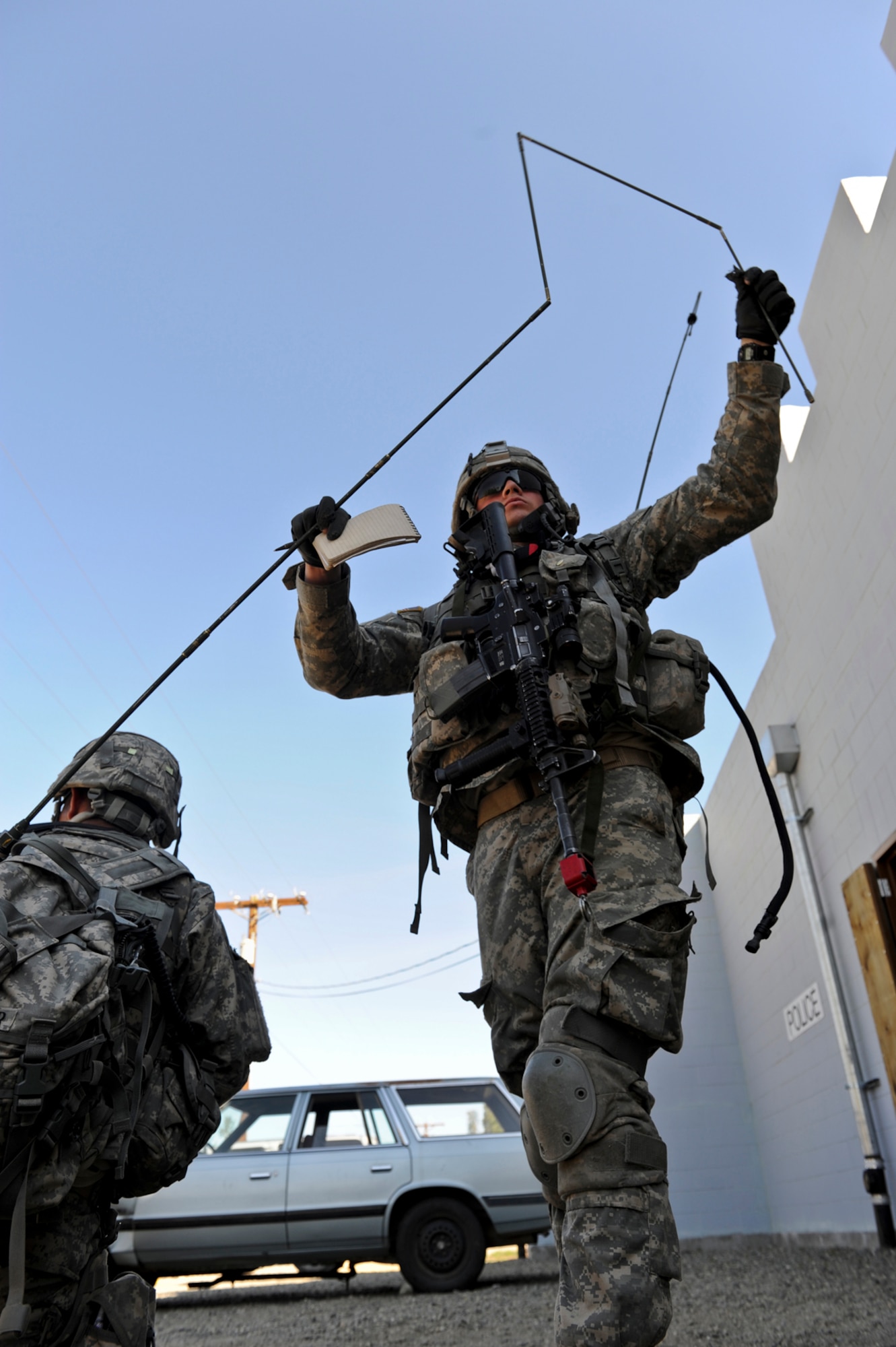 JOINT BASE ELMENDORF-RICHARDSON, Alaska ??? Soldiers stationed at Joint Base Elmendorf-Richardson with 4th Brigade Combat Team (Airborne), 25th Infantry Division, extend a radio antenna for communication while monitoring ???locals??? during an urban operations training exercise at Donnelly Training Area, June 7. Actors helped play a role in the Soldiers??? training and made the scenarios seem more realistic. (U.S. Air Force photo/ Airman 1st Class Jack Sanders)