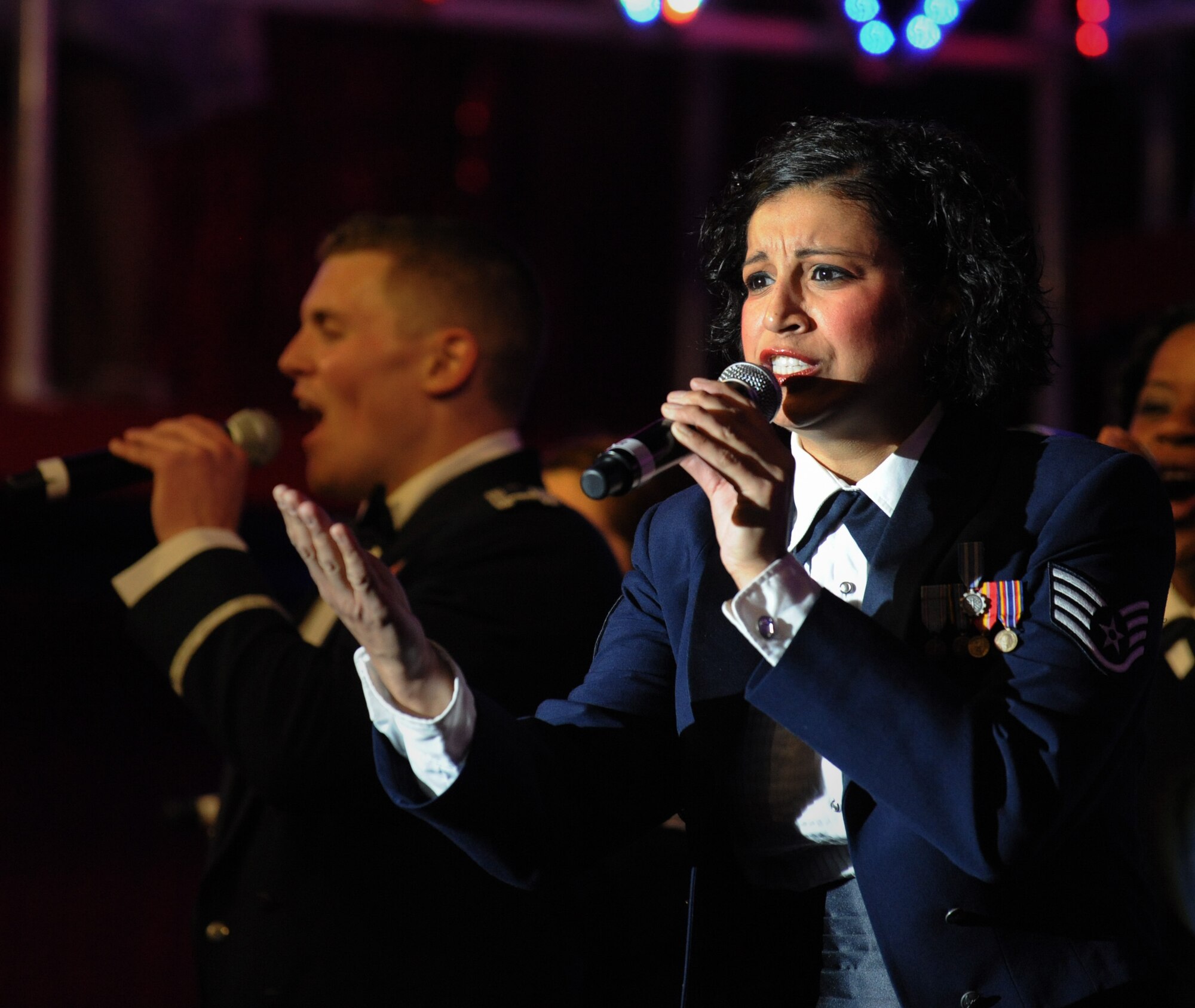 MOUNTAIN HOME AIR FORCE BASE, Idaho – Staff Sgt. Abigail Foster, a non-destructive inspection journeyman with the 92nd Maintenance Squadron, Joint Base San Antonio – Lackland AFB, Texas, sings “God Bless the USA,” the final number of the show, during the Tops in Blue Rhythm Nation Tour here June 18. Tops in Blue is composed of 35 to 40 vocalists, musicians, dancers, and technicians. (U.S. Air Force photo by Staff Sgt. Gina Chiaverotti-Paige)