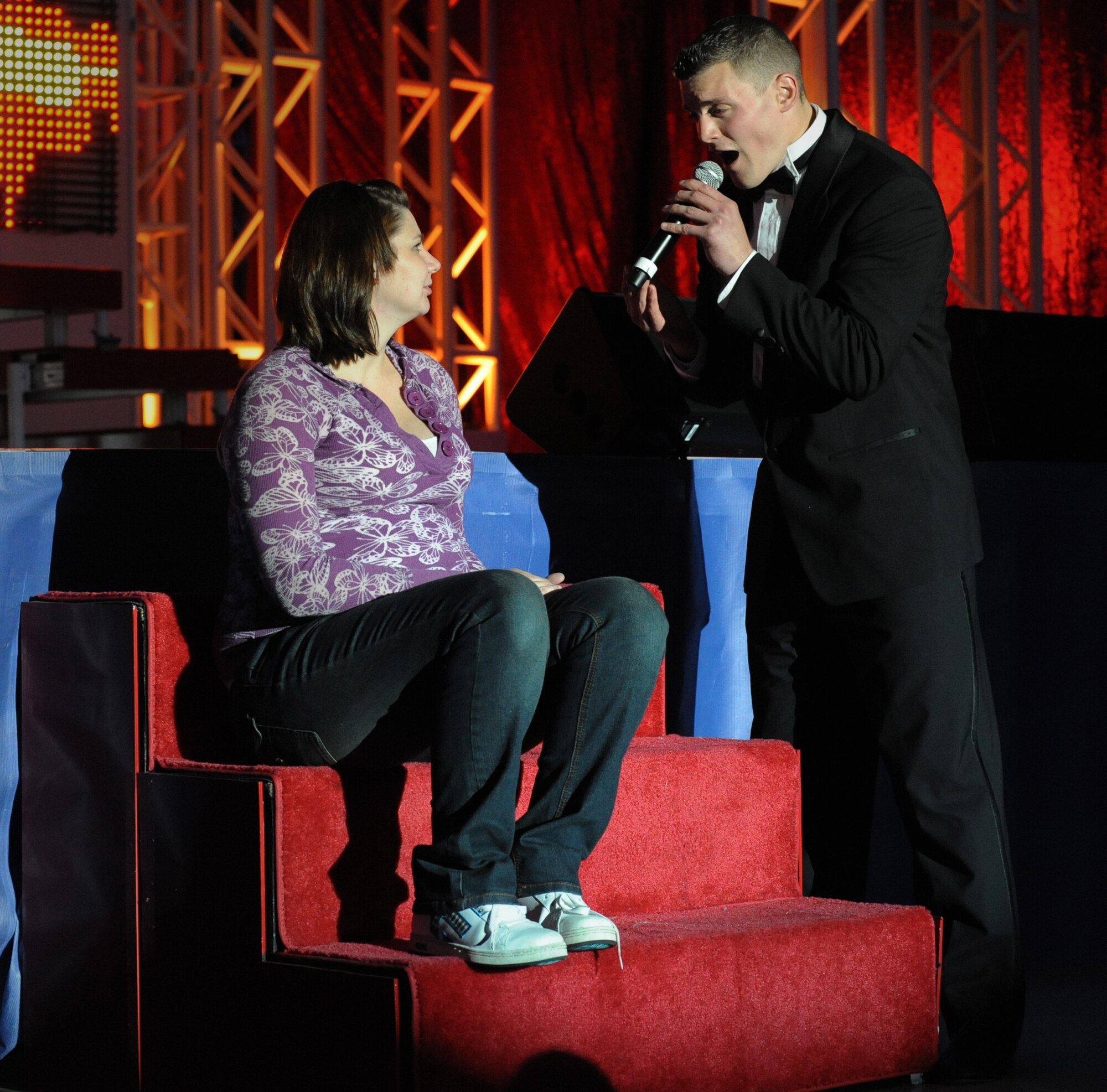 MOUNTAIN HOME AIR FORCE BASE, Idaho – Senior Airman Debbie Lockhart, 366th Fighter Wing public affairs photographer, is serenaded by 1st Lt. Robert Doyle, an acquisitions program manager with the 4th Space Launch Squadron, Vandenberg AFB, Ca., during the Tops in Blue Rhythm Nation Tour here June 18. The tour runs from June until the beginning of December with close to 140 performances. (U.S. Air Force photo by Staff Sgt. Gina Chiaverotti-Paige)