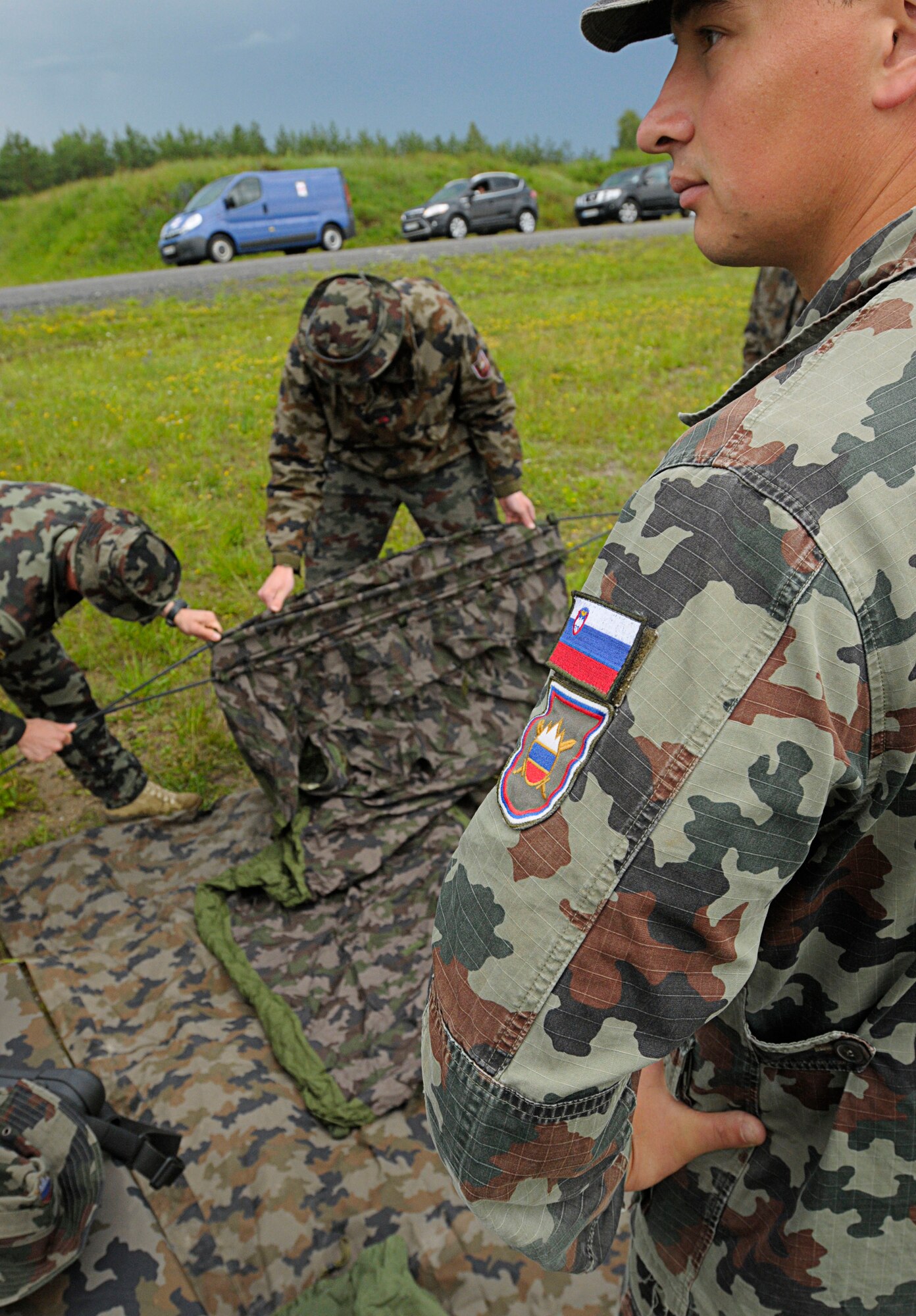 Slovenian army personnel prepare for a static display of their tactical reconnaissance equipment before the opening ceremony for Allied Strike 2011 at Grafenwoher Training Area, Germany, June 22, 2011. Allied Strike is Europe's premier Close Air Support exercise, held annually to conduct robust, realistic CAS training that helps build partnership capacity among Allied NATO nations and refine the latest operational CAS tactics. (U.S. Air Force photo by Airman 1st Class Desiree W. Esposito)