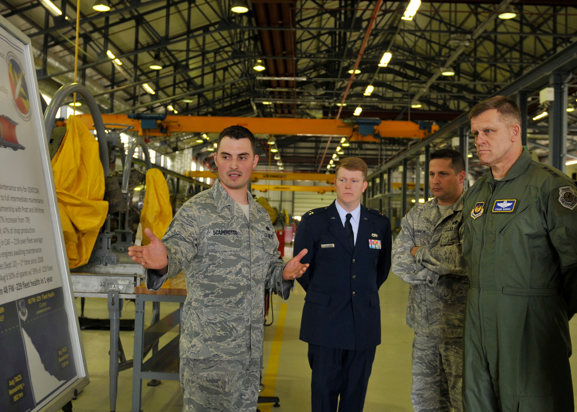 ROYAL AIR FORCE LAKENHEATH, England - Staff Sgt. Charles Scaperotto, 48th Component Maintenance Squadron jet engine craftsman, explains successes due to Air Force Smart Operations for the 21st Century to Lt. Gen. Frank Gorenc, 3rd AF commander, at the propulsion shop during his base visit, June 23, 2011. General Gorenc visited multiple base facilities to see the 48th Fighter Wing mission up close and recognize Liberty Airmen. (U.S. Air Force photo/Senior Airman Tiffany M. Deuel)
