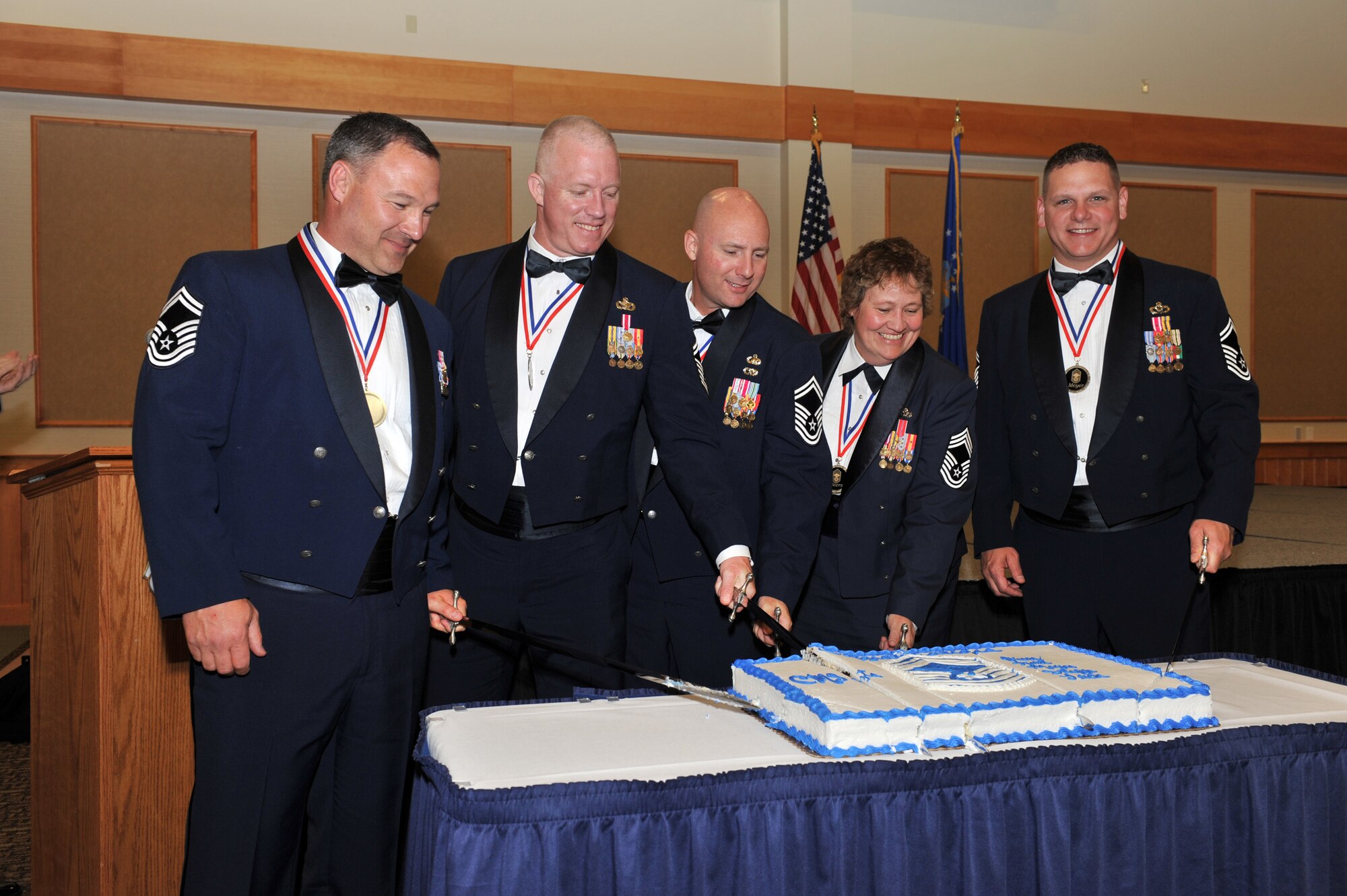 The newest chief master sergeant selects cut their celebratory cake at the Chiefs Recognition Banquet June 17 at the Grizzly Bend. The ceremony was held to recognize them for their selection to the top enlisted rank.   (U.S. Air Force photo/John Turner)