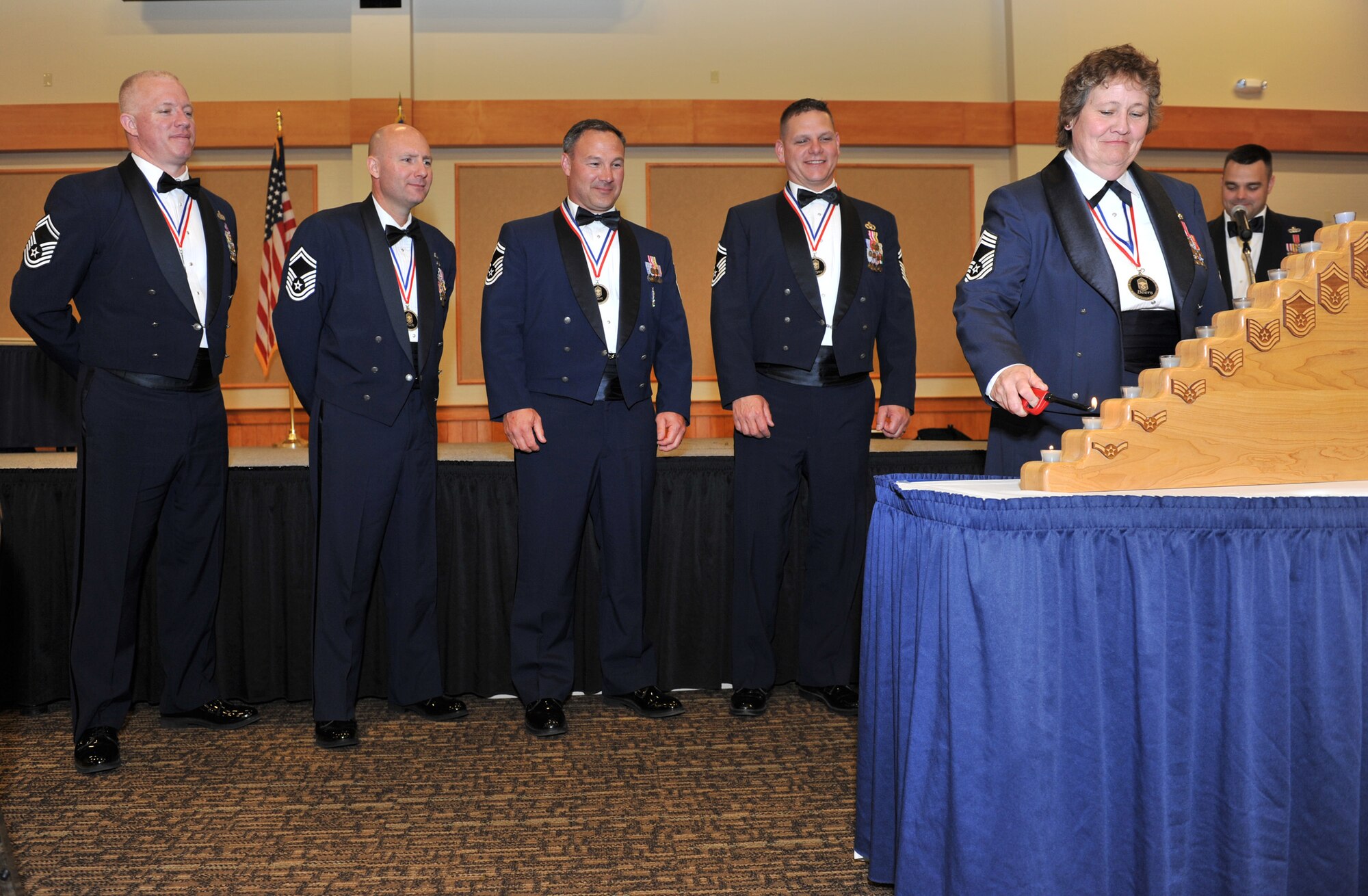 From left to right: Senior Master Sgts. Derick Stepp, 341st Security Forces Squadron security forces manager; David Tuck, 341st Contracting Squadron superintendent; Chriss Hart, 341st Missile Maintenance Squadron maintenance superintendent; and William Meyer, 341st Civil Engineer Squadron chief enlisted manager; watch as Chief Master Sgt. Karen Beers, 819th RED HORSE Squadron chief of operations, lights the first few candles during the candle lighting ceremony.  Each candle that is lit represents a different enlisted rank reminding the chiefs where they started from.  (U.S. Air Force photo/John Turner)