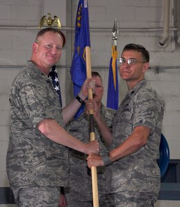 Lt. Col. Craig Punches accepts the 628th Logistics Readiness Squadron guidon from Col. Benjamin Wham during the 628 LRS Change of Command June 23 at Joint Base Charleston. Colonel Punches is the new 628 LRS commander and Colonel Wham is the 628th Mission Support Group commander. (U.S. Air Force photo/ Tech. Sgt. Robert Gibson) 

