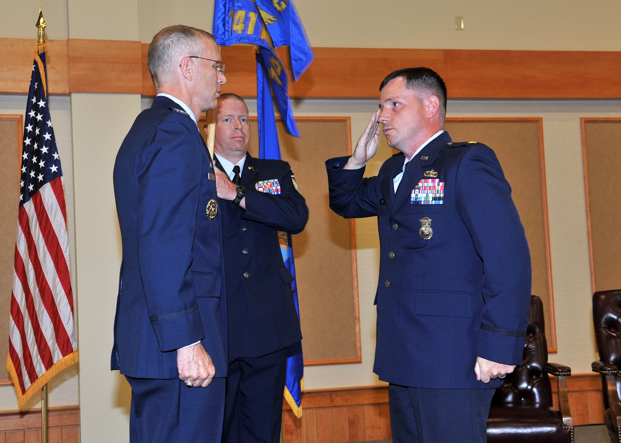 Maj. Patrick J. Steen, right, salutes Col. Robert K. Mendenhall, 341st Security Forces Group commander, after assuming command of the 741st Missile Security Forces Squadron June 16 at the Grizzly Bend.  Holding the guidon is 741st MSFS first sergeant Master Sgt. Herbert Carroll. (U.S. Air Force Photo/John Turner)