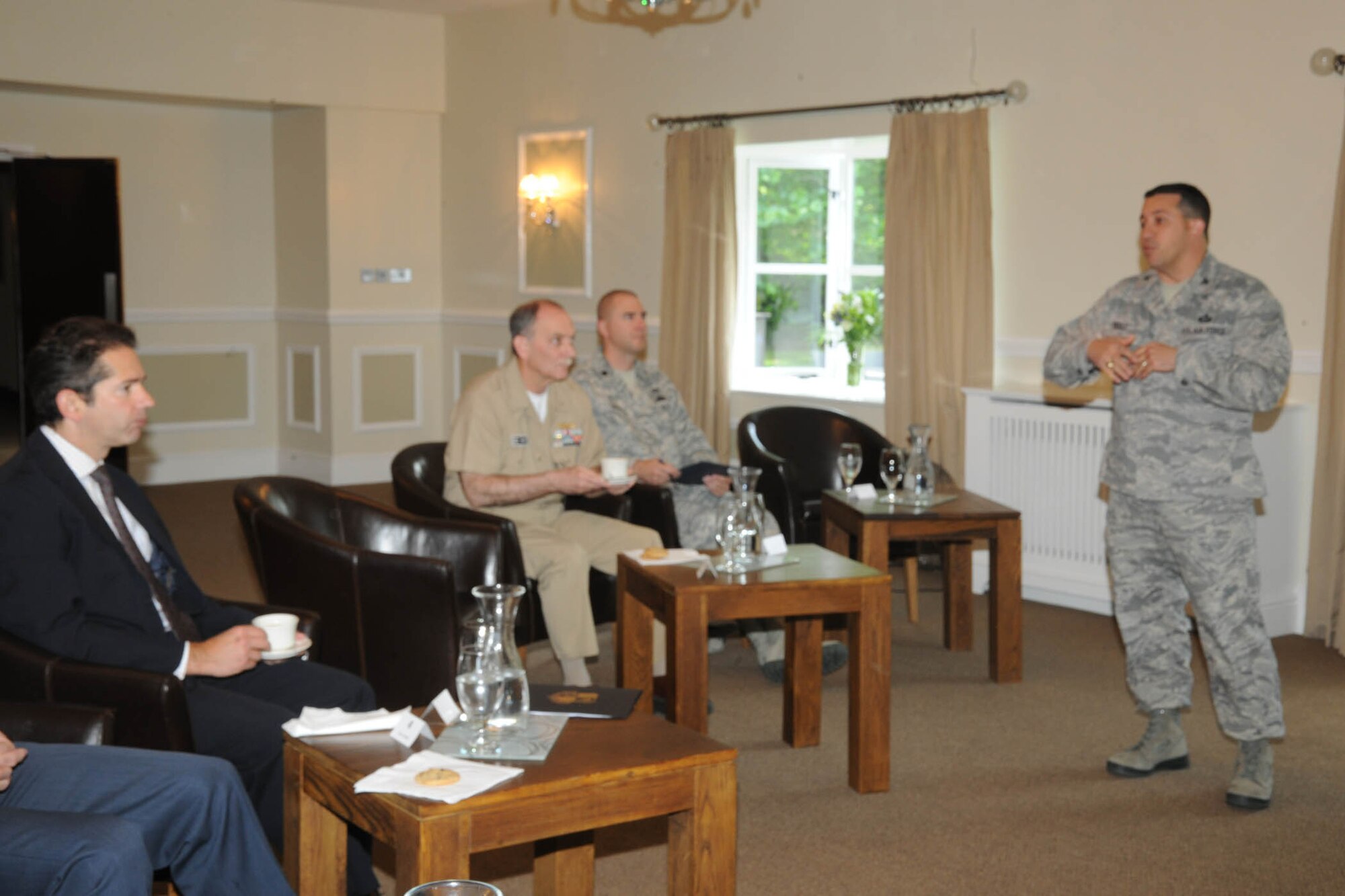 Colonel Brian Kelly gives a wing mission briefing to Mr. Jonathan Djanogly (left), Member of Parliament for Huntingdon, at the Stukeley Inn at RAF Alconbury June 24. Mr. Djanogly visited the base as part of a familiarization visit. 