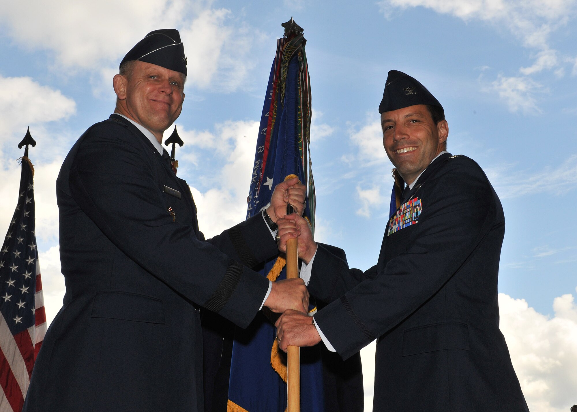 RAF MILDENHALL, England -- Col. Christopher Kulas, 100th Air Refueling Wing incoming commander, receives the guidon from Lt. Gen. Frank Gorenc, 3rd Air Force commander, as he takes command of the 100th ARW June 24, 2011, during the wing change command ceremony at Hangar 814. Colonel Kulas was formerly the 379th Expeditionary Operations Group commander, 379th Air Expeditionary Wing, Southwest Asia.  (U.S. Air Force photo/Senior Airman Tabitha M. Lee)