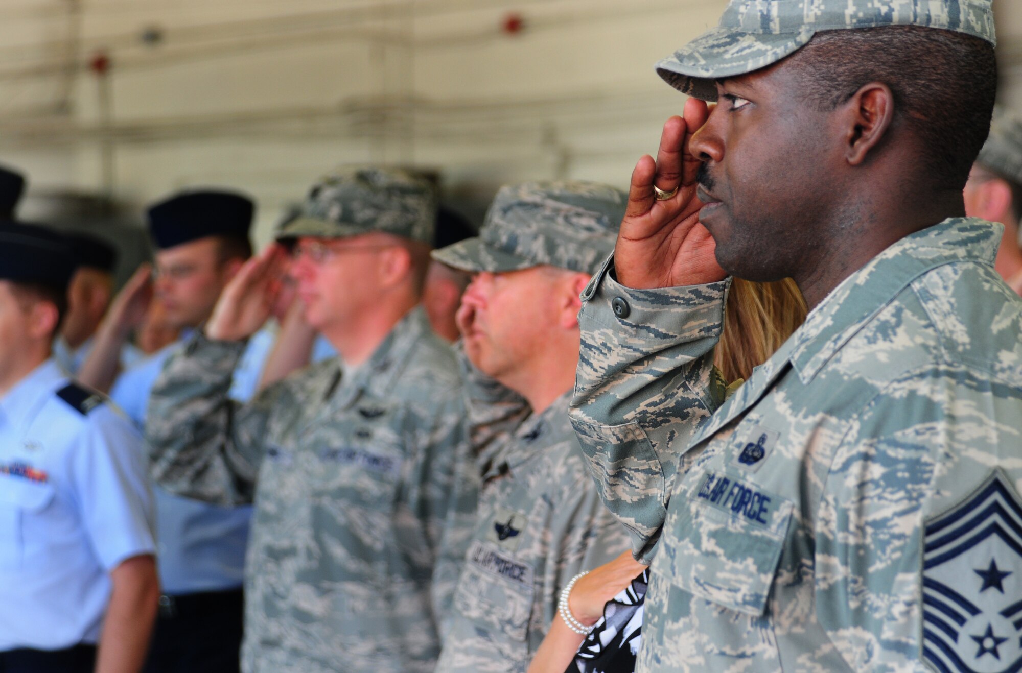 Chief Master Sgt. Marcus Snoddy, 39th Air Base command chief, salutes during the Turkish and American national anthems at the 39th CES change-of-command ceremony, June 23, 2011, at Incirlik Air Base, Turkey. Maj. John Sevier accepted command of the squadron, replacing Lt. Col. Dwayne McCullion. (U.S. Air Force photo by Senior Airman Anthony Sanchelli/Released)