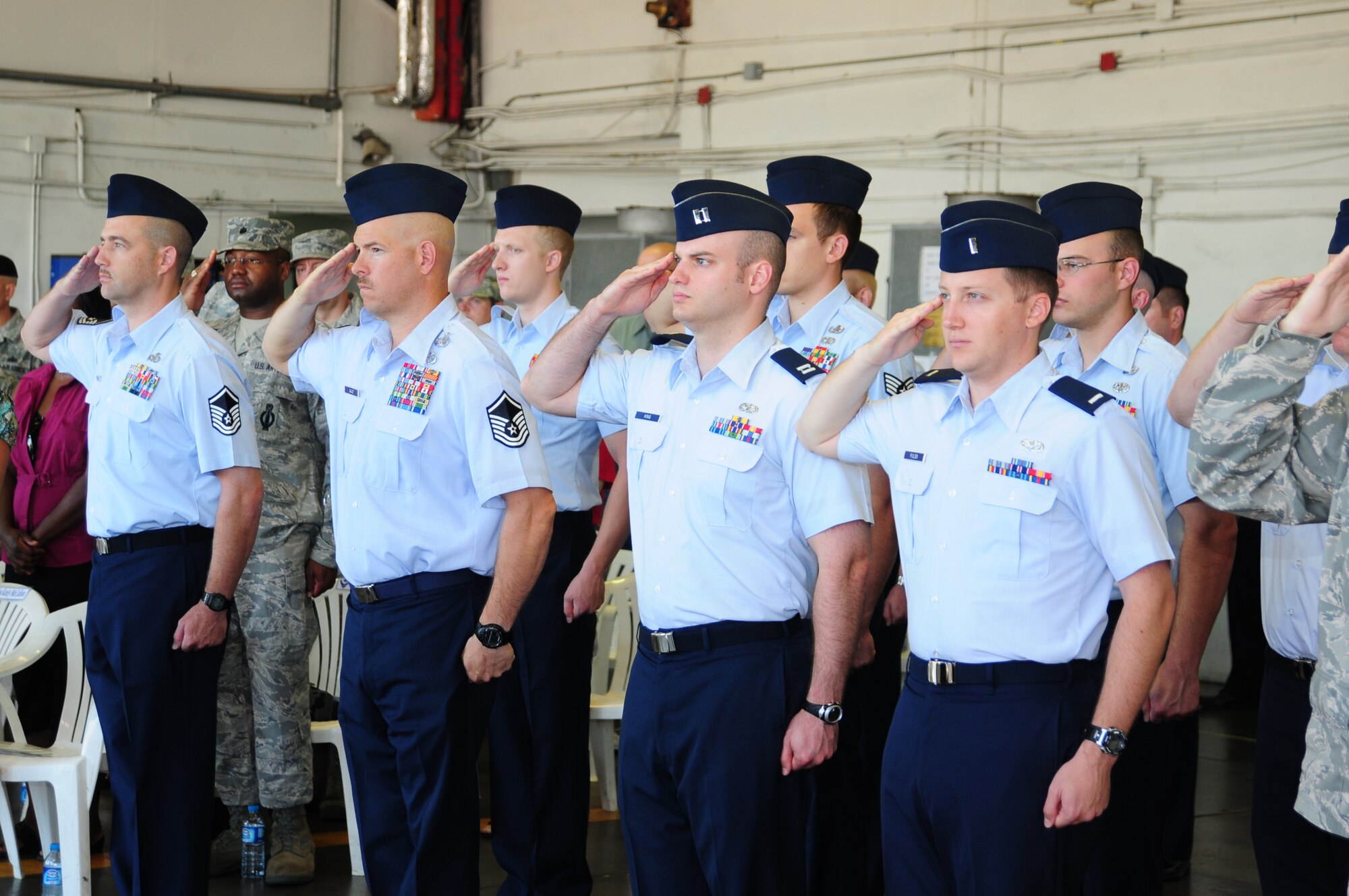 Members of the 39th Civil Engineer Squadron salute during the Turkish and American national anthems at the 39th CES change-of-command ceremony, June 23, 2011, at Incirlik Air Base, Turkey. Maj. John Sevier accepted command of the squadron, replacing Lt. Col. Dwayne McCullion. (U.S. Air Force photo by Senior Airman Anthony Sanchelli/Released)