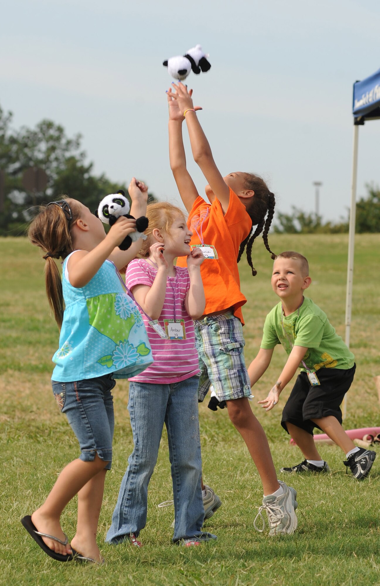 (From left) Abigail Phillips, Amber Hale, Jania Evans, and Quinton Huet compete for a toy panda bear on June 16, 2011, during vacation Bible school at Little Rock Air Force Base, Ark.   This year’s vacation Bible school theme was “PandaMania” and taught life values to children through entertainment and activities.   (U.S. Air Force photo by Tech. Sgt. Chad Chisholm) 