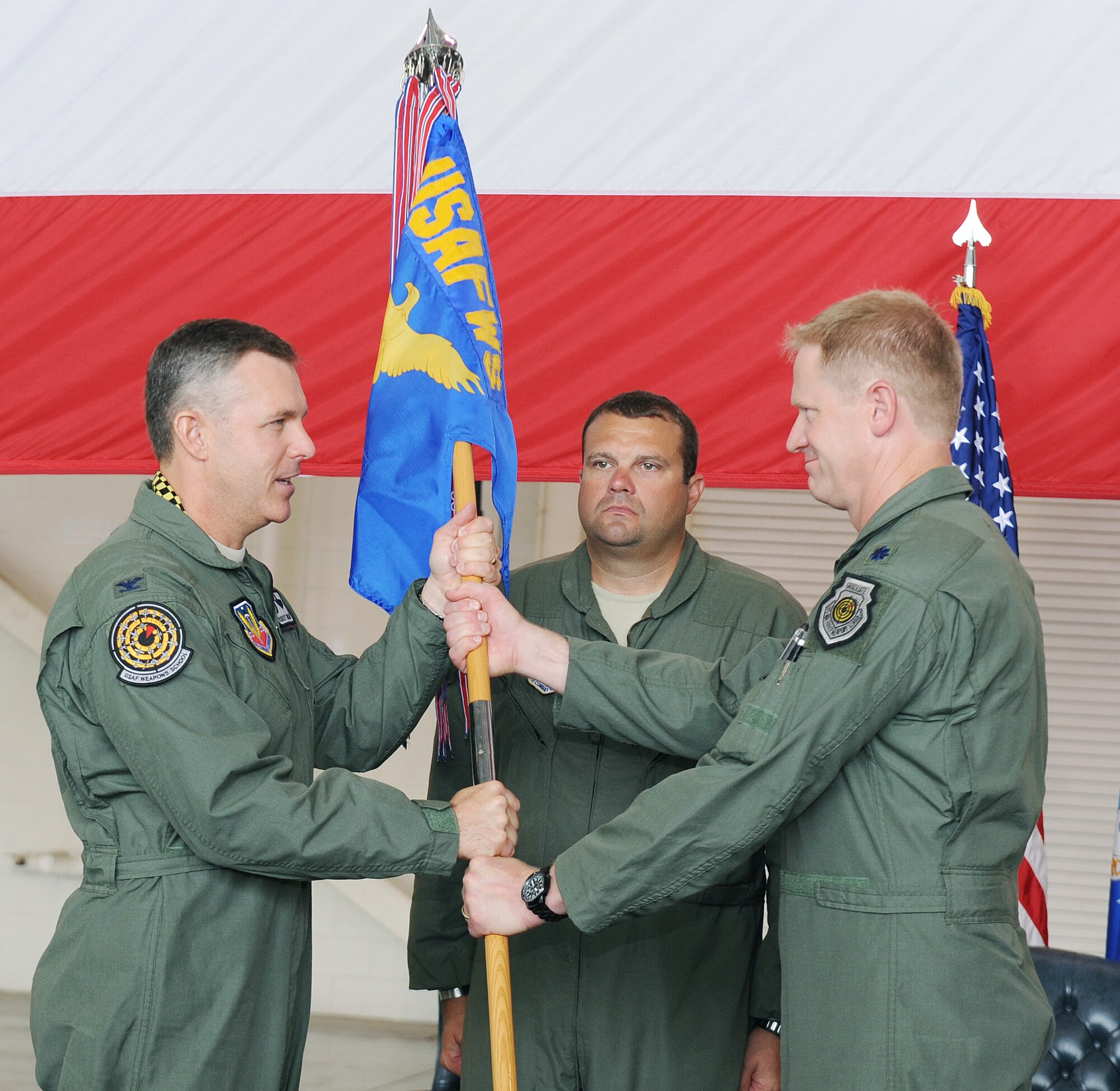 Lt. Col. Todd White (right), incoming 29th Weapons Squadron commander, accepts the guidon from Col. Robert Garland, United States Air Force Weapons School commandant, and as such, command of the unit June 21, 2011, at Little Rock Air Force Base, Ark. The 29th WS has graduated 215 weapons officers for the C-130 J-, E- and H-models since its inception in 2003. (U.S. Air Force photo/Airman 1st Class Ellora Remington)