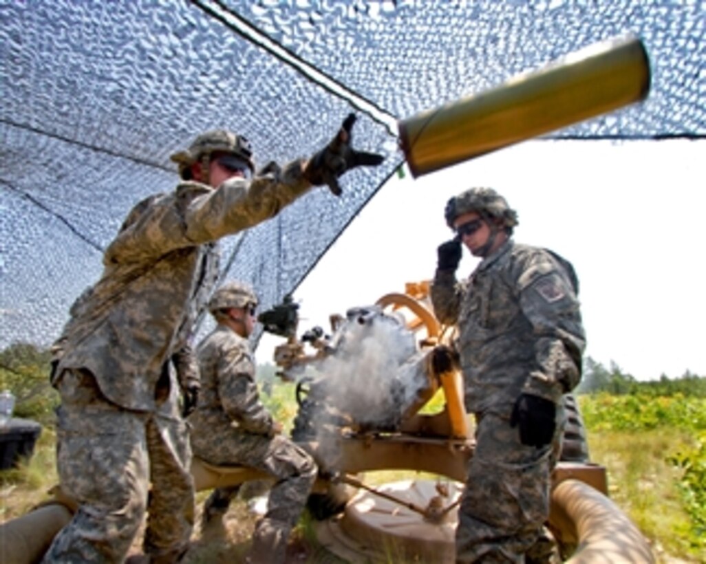 U.S. Army Sgt. Adam Phillips tosses an empty canister from an M119A2 105mm howitzer during platoon evaluations at Fort Bragg, N.C., on June 15, 2011.  Phillips is a paratrooper assigned to the 82nd Airborne Division's 3rd Battalion, 319th Airborne Field Artillery Regiment, 1st Brigade Combat Team.  
