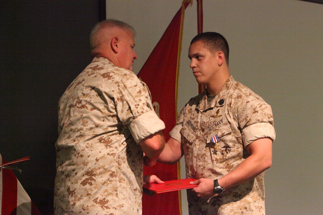 Navy Petty Officer First Class Amilcar Rodriguez, a corpsman previously assigned to 2d Marine Special Operations Battalion, U.S. Marine Corps Forces, Special Operations Command, shakes hands with MARSOC commander Maj. Gen. Paul E. Lefebvre during an awards ceremony at MARSOC Headquarters June 24, 2011, in which he was awarded the Silver Star for his extraordinary heroism while conducting combat operations in Bala Morghab, Afghanistan Nov. 6, 2009. The Silver Star is the nation's third-highest military decoration for valor in combat.
